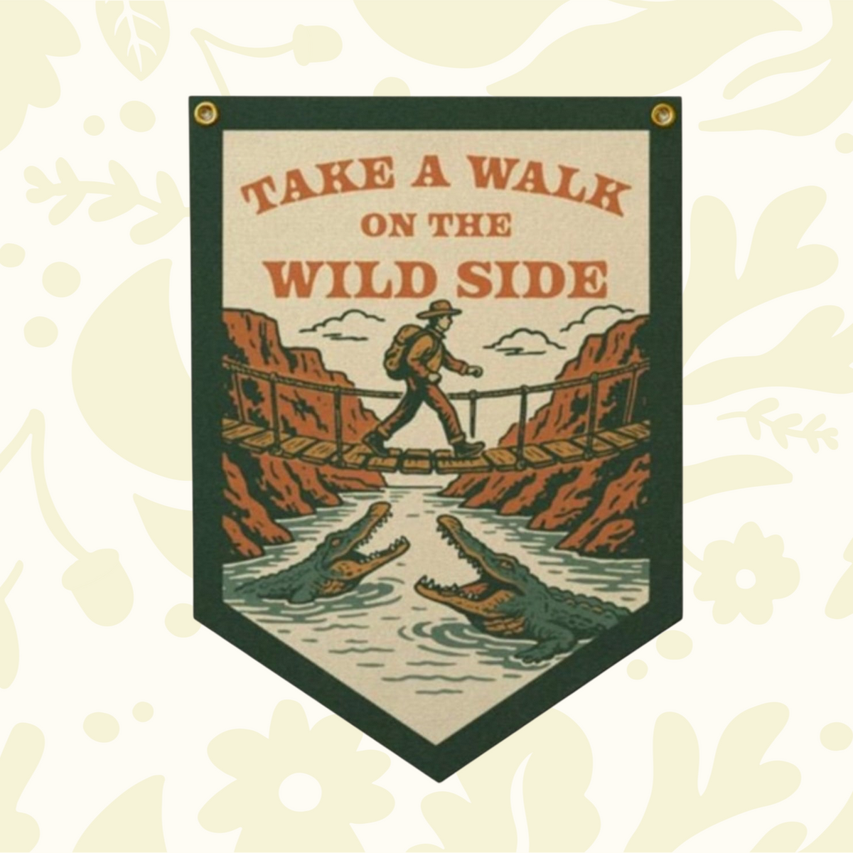 Forager Provisions LTD handmade felt pennant featuring a retro adventure illustration of a hiker crossing a crocodile river
