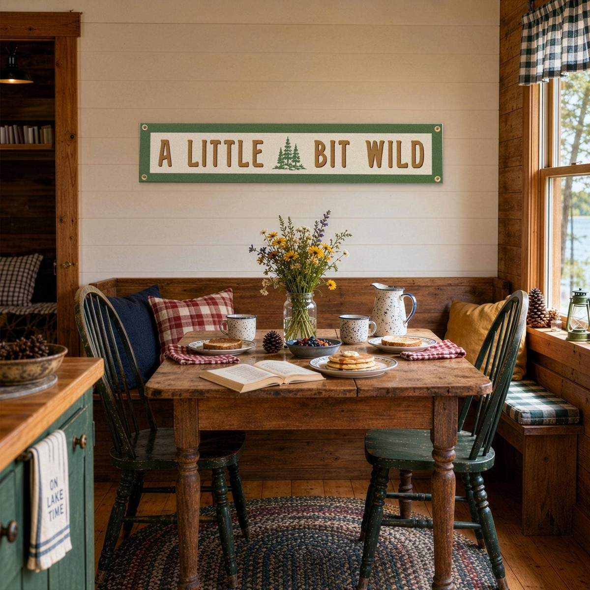 Forager Provisions LTD Benoit's Design Co. A Little Bit Wild felt wall banner hanging in a rustic cabin dining room.
