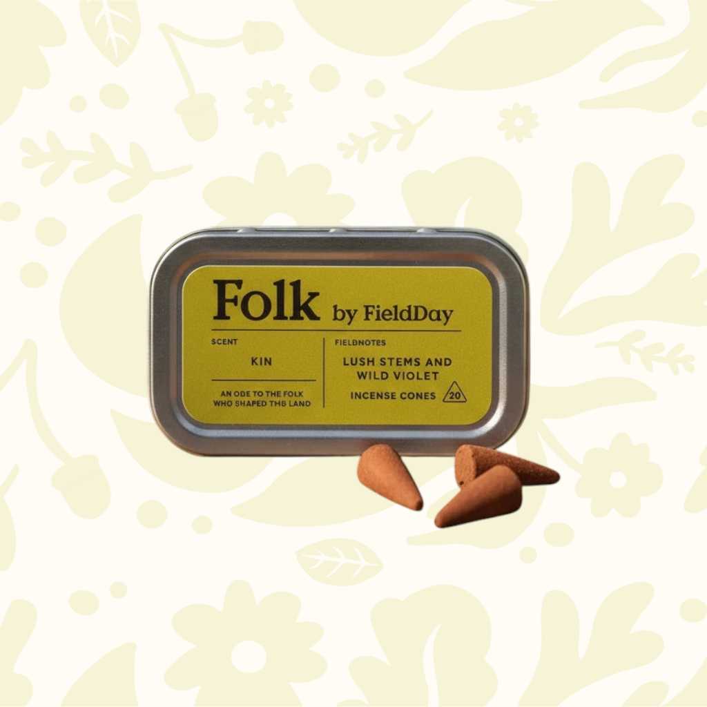FieldDay Ireland Kin Folk Incense tin and 3 cones, floral backdrop, evokes Irish countryside scents, home fragrance decor.