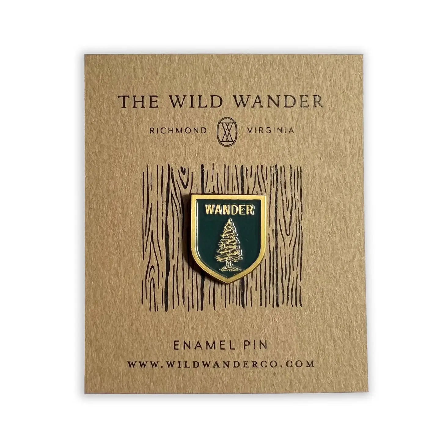 Forager Provisions LTD enamel scout shield pin featuring a fir tree and Wander text on a kraft backing card