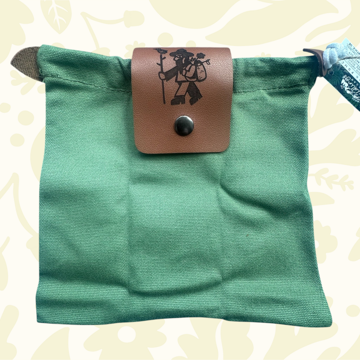 Forager Provisions LTD green up-cycled cotton canvas pouch with a branded vegan leather flap in a woodland setting