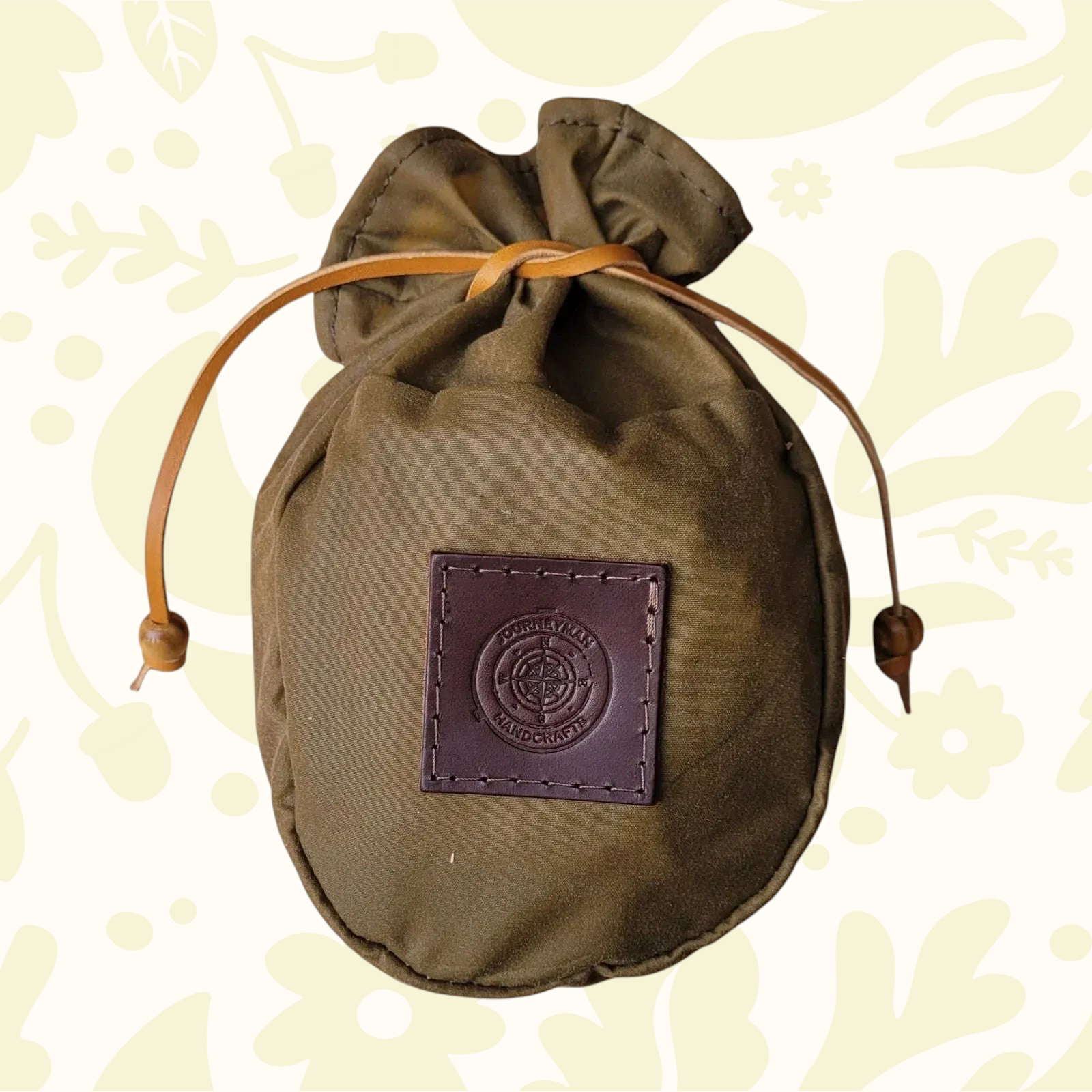 Forager Provisions LTD Journeyman Handcraft khaki brown waxed canvas coffee pouch with a leather drawstring closure.
