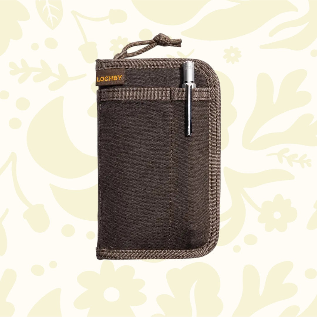 Forager Provisions LTD Lochby brown waxed canvas pocket journal with a metal pen in the front sleeve