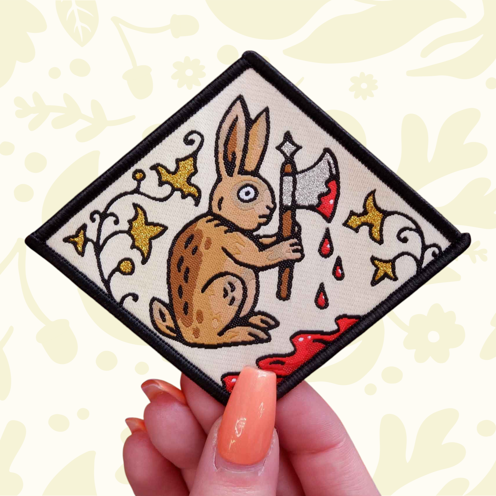 Forager Provisions LTD Cat Coven woven patch featuring a medieval rabbit holding an axe against a manuscript background