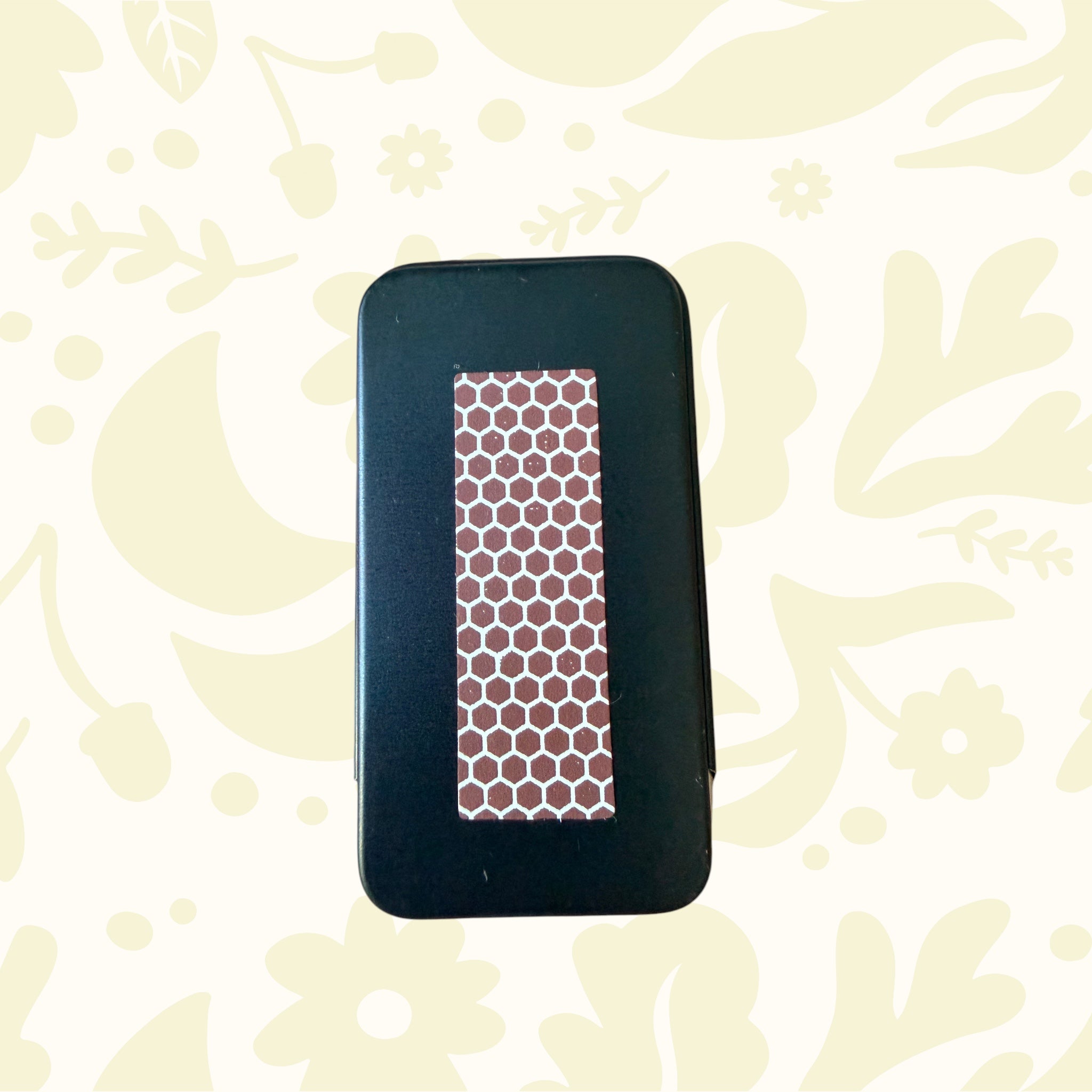 Forager Provisions LTD metal stash tin featuring a brown honeycomb match striker surface on the back