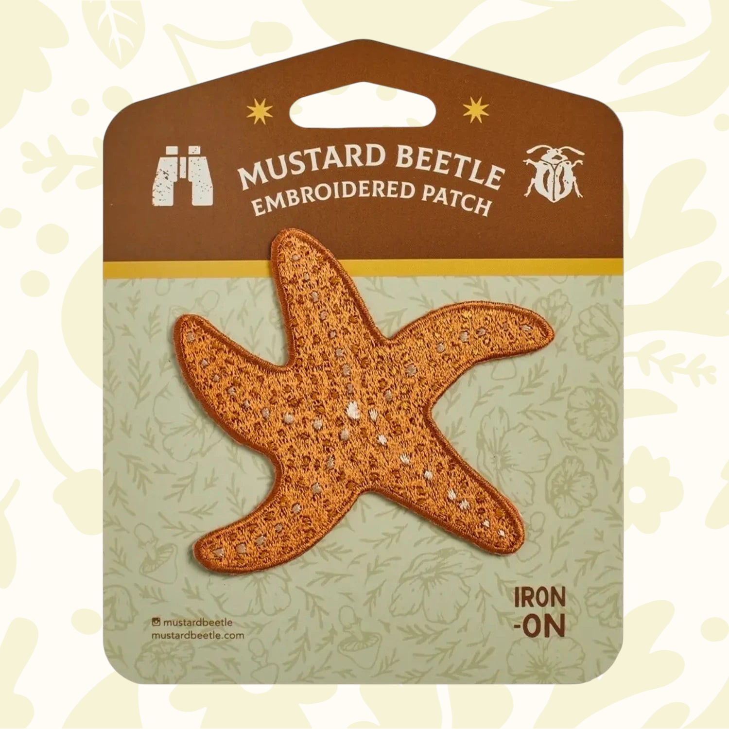 Forager Provisions LTD Mustard Beetle ochre starfish iron-on embroidered patch on branded display card.