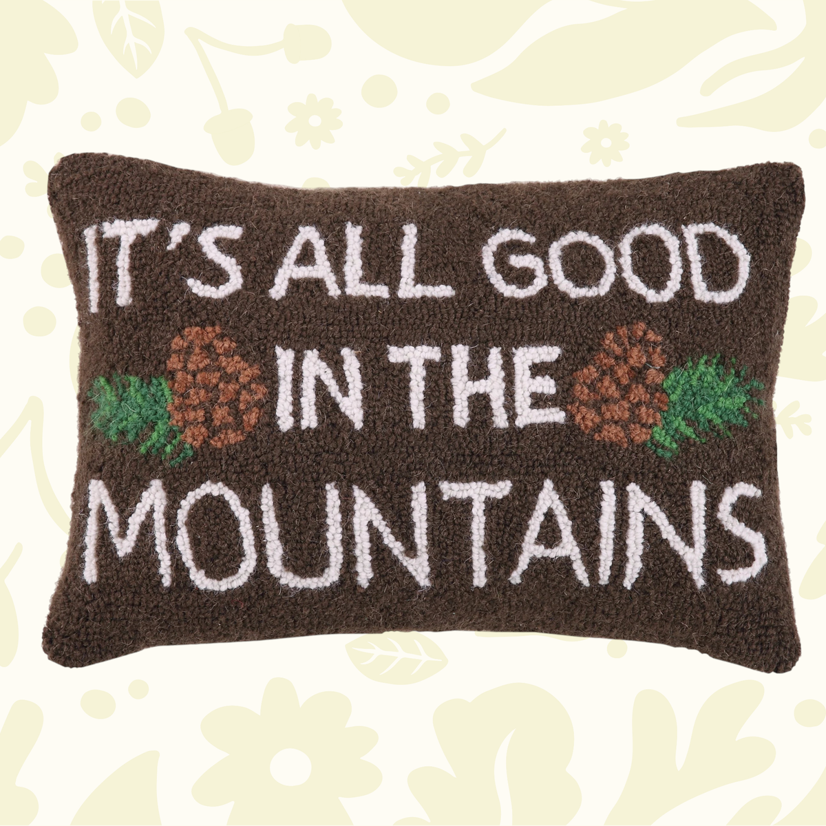 Forager Provisions LTD Peking Handicraft hooked wool cushion featuring a mountain slogan and pinecone design.
