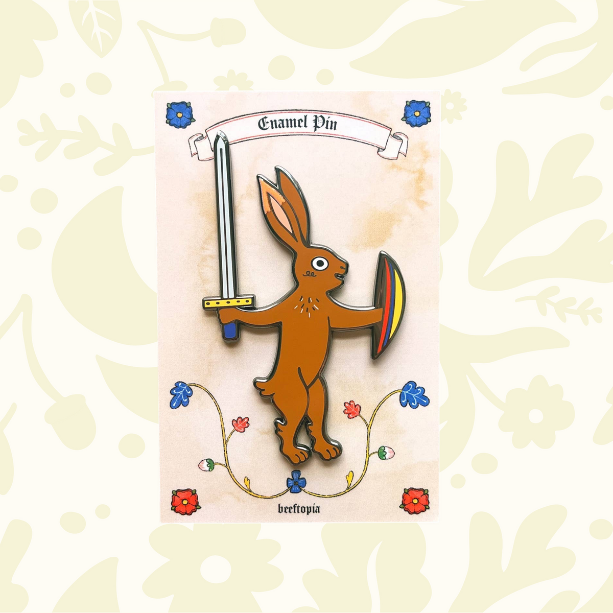 Forager Provisions LTD Beeftopia enamel pin featuring a brown rabbit holding a sword and shield on a floral card