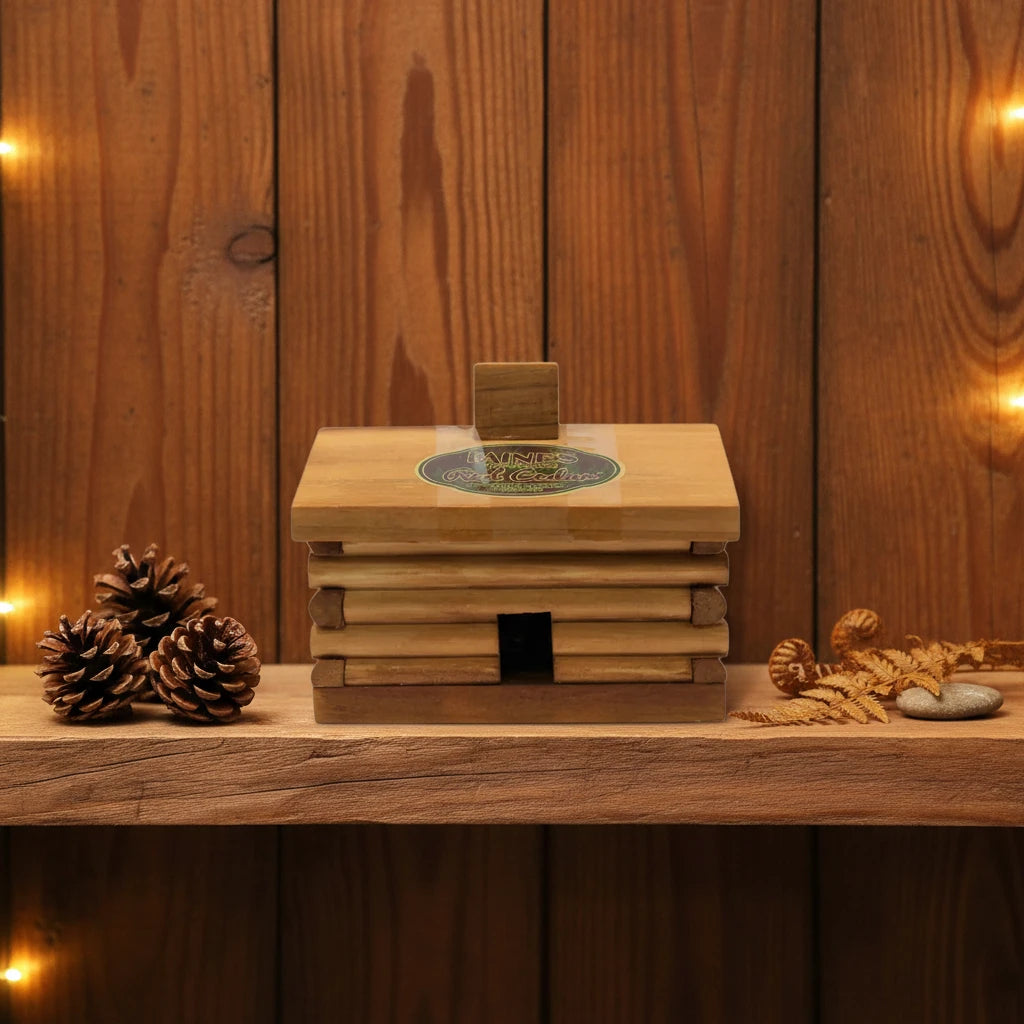 PAINES Red Cedar 10 Incense Cones Large Log Cabin box on shelf with pinecones and leaves, cedar scent aroma decor.