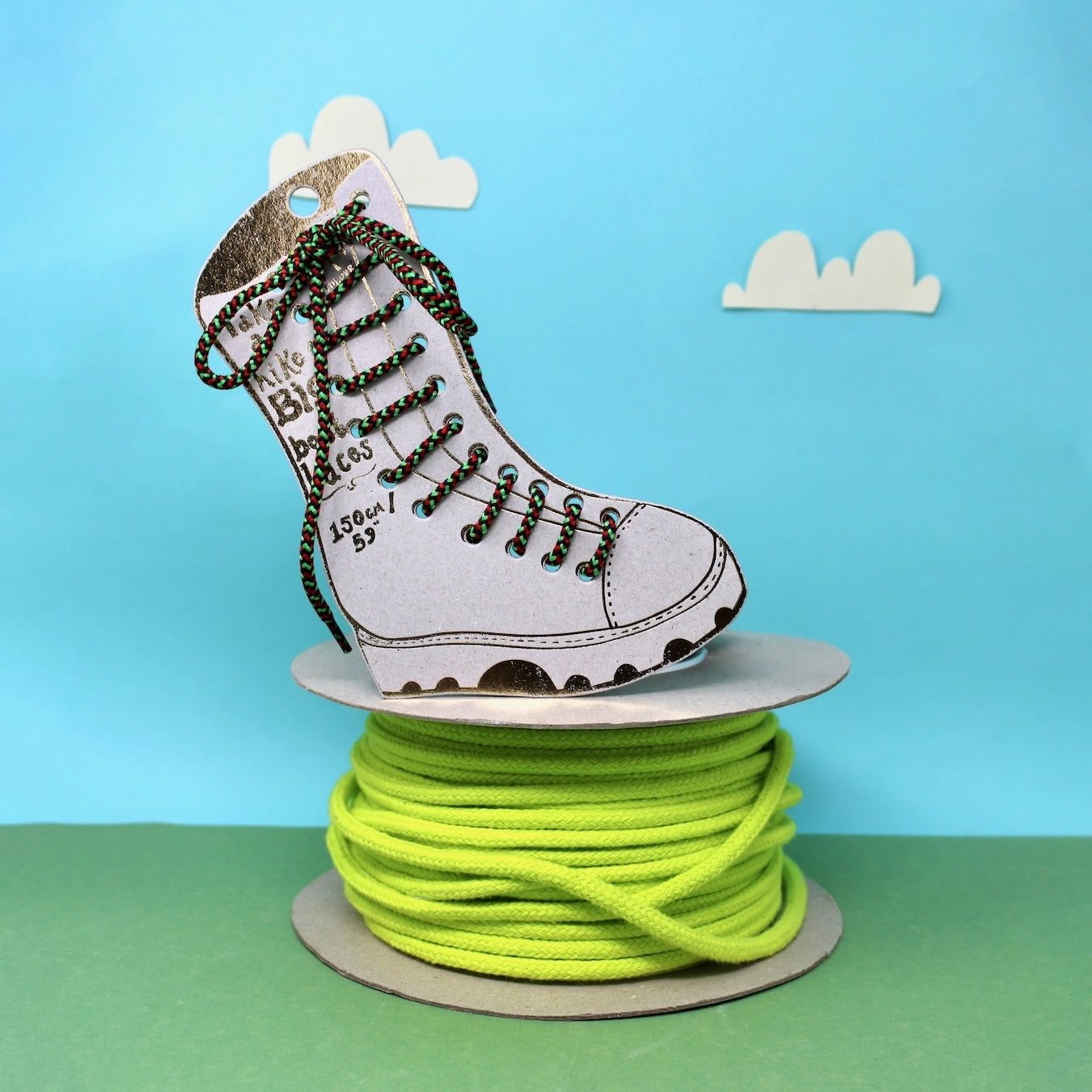 Forager Provisions LTD Ark Colour Design red and green patterned boot laces on a spool with a boot-shaped display card