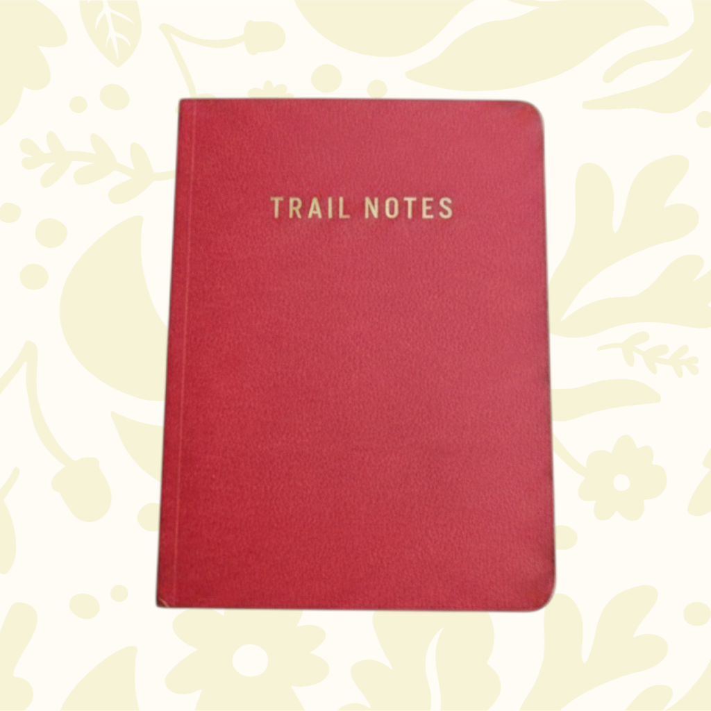 Forager Provisions LTD Trail Notes red pocket-sized field journal for hikers with gold embossed text on the cover.