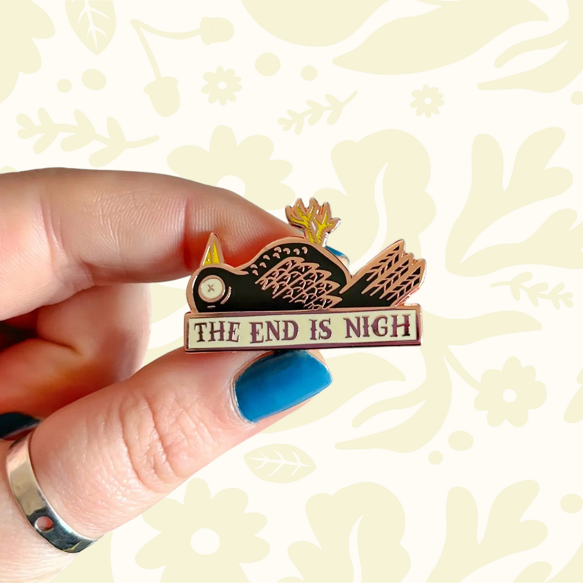 Forager Provisions LTD The End Is Nigh enamel pin featuring a skeletal bird design with gold-tone metal detailing.