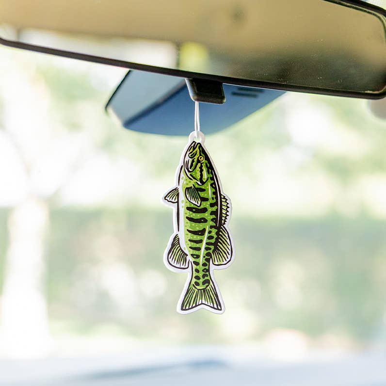 Forager Provisions LTD Smallmouth Bass air freshener hanging from a car rearview mirror with wild lemongrass scent.