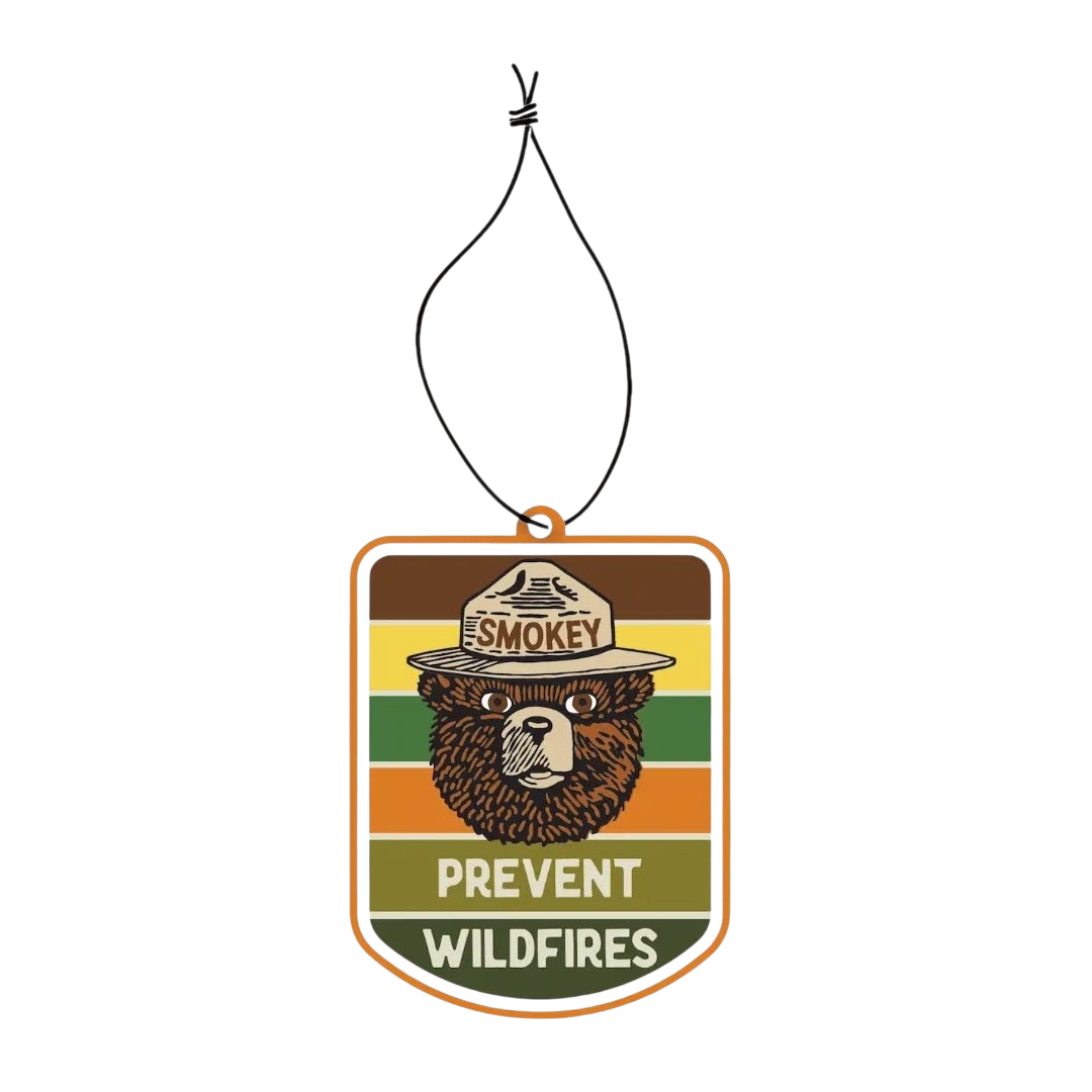Forager Provisions LTD Smokey Bear hanging air freshener with retro striped background and pine and citrus scent.
