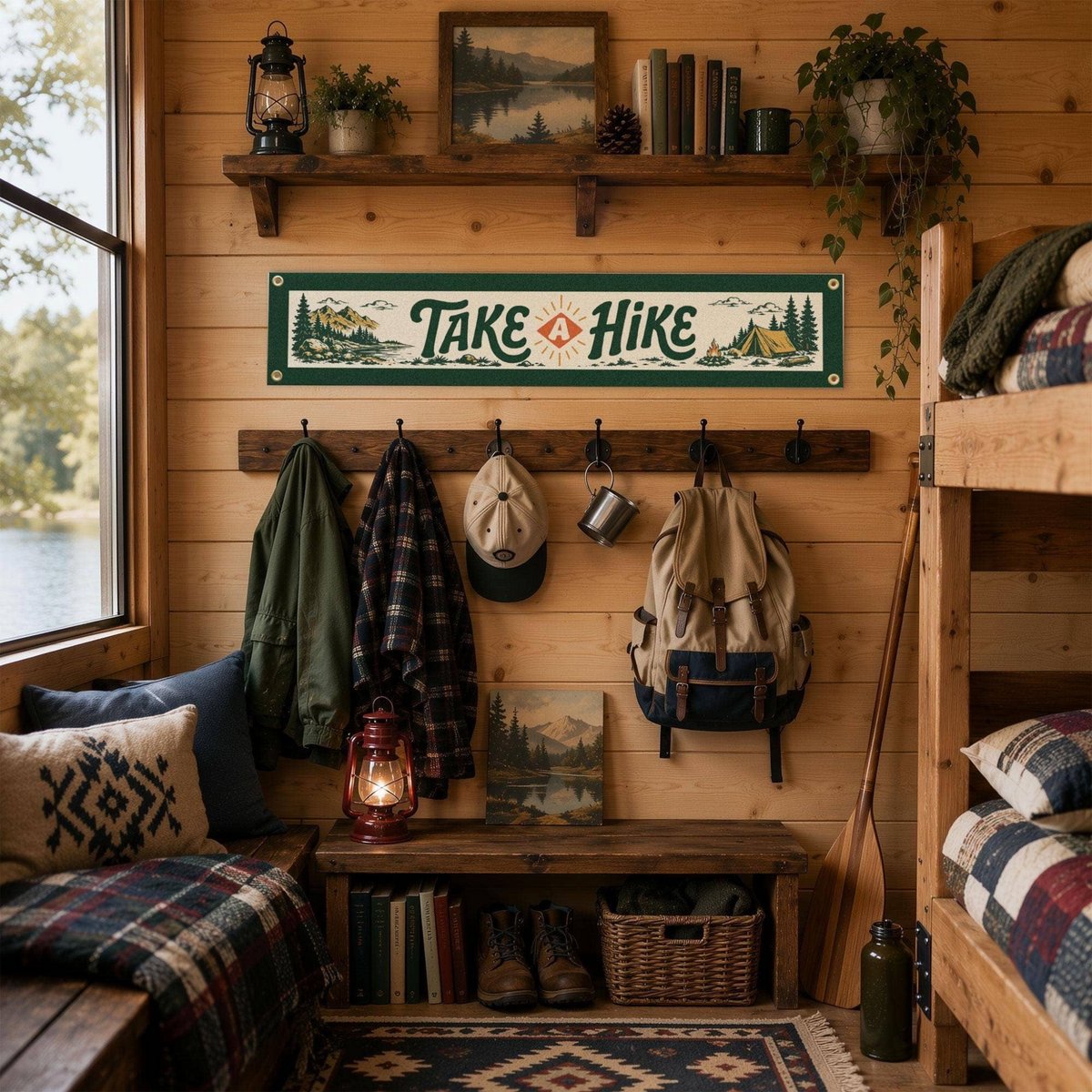 Forager Provisions LTD Take A Hike felt banner hanging in a rustic cabin with outdoor decor and hiking gear.
