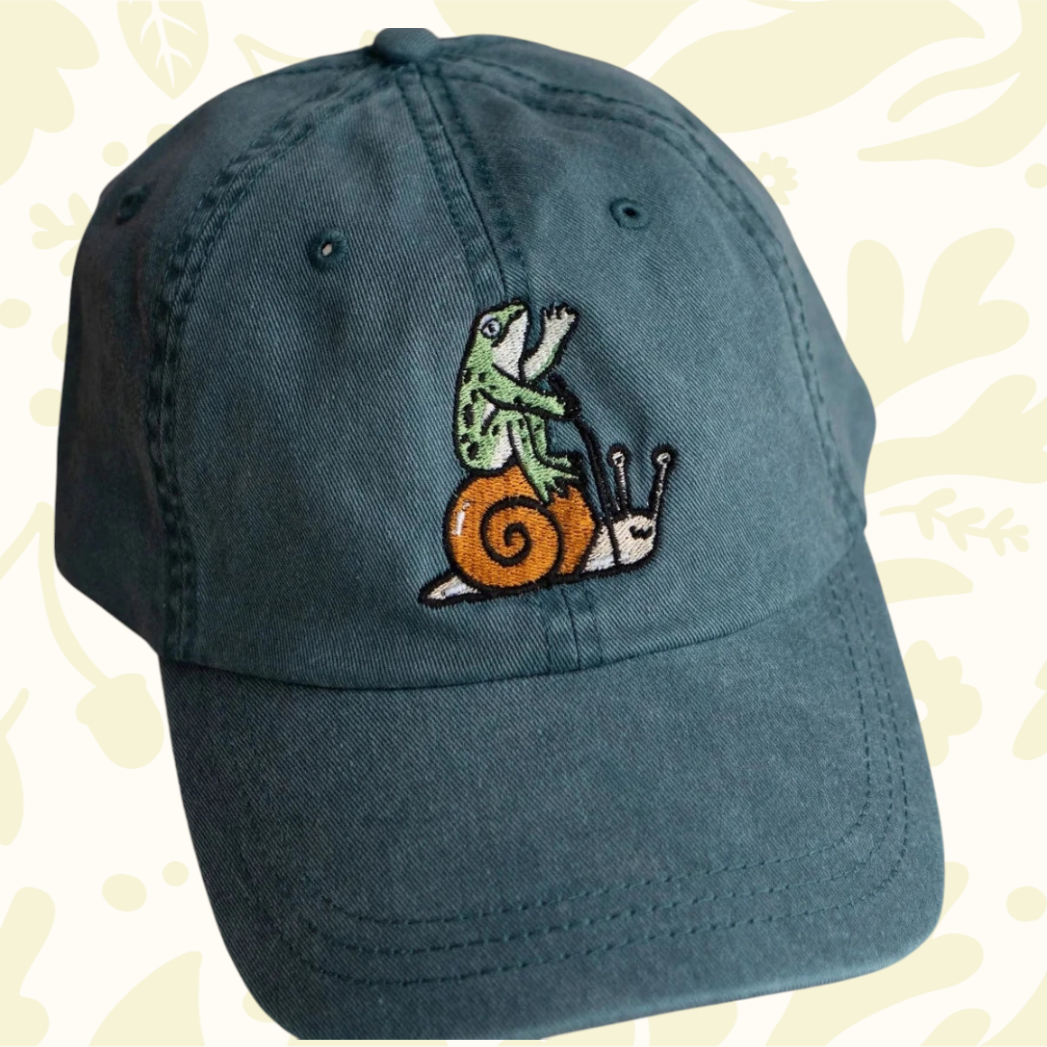 Forager Provisions LTD Stay Home Club vintage teal cotton dad cap featuring an embroidered frog riding a snail.