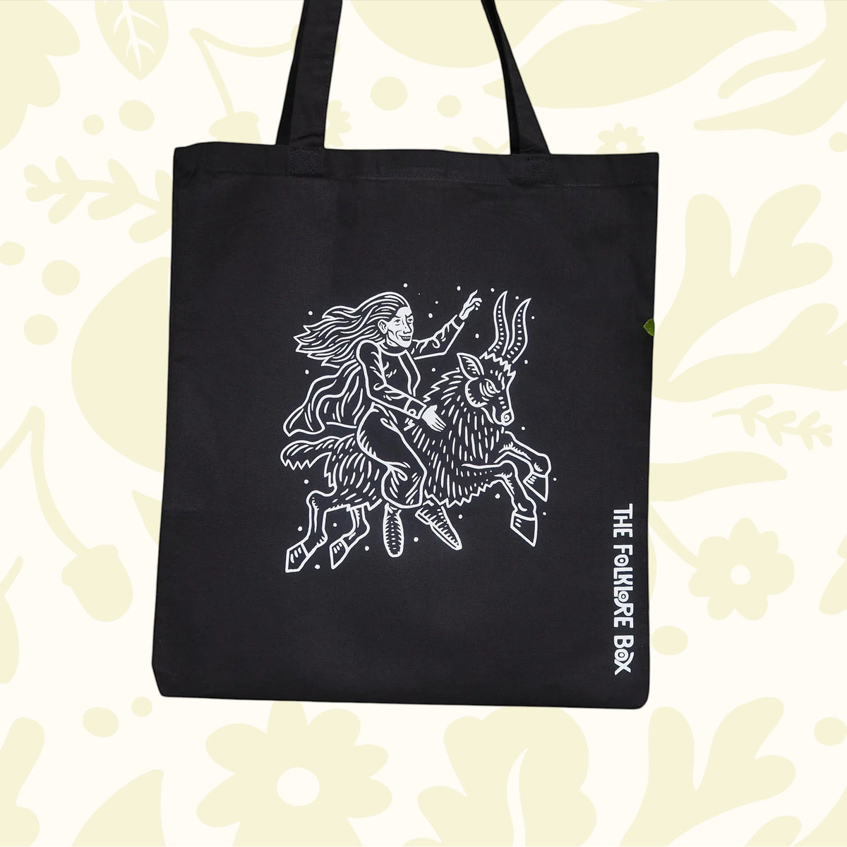Forager Provisions LTD black cotton tote bag featuring a white Matt Willis witch riding a goat folklore illustration.