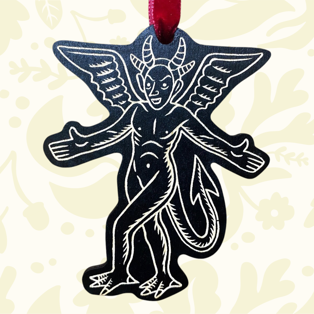 Forager Provisions LTD matte black birch plywood devil hanging decoration with silver outline and red velvet ribbon.