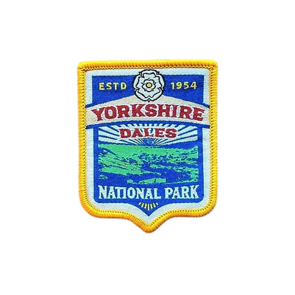 Forager Provisions LTD embroidered Yorkshire Dales National Park patch with a yellow border on a wooden background.
