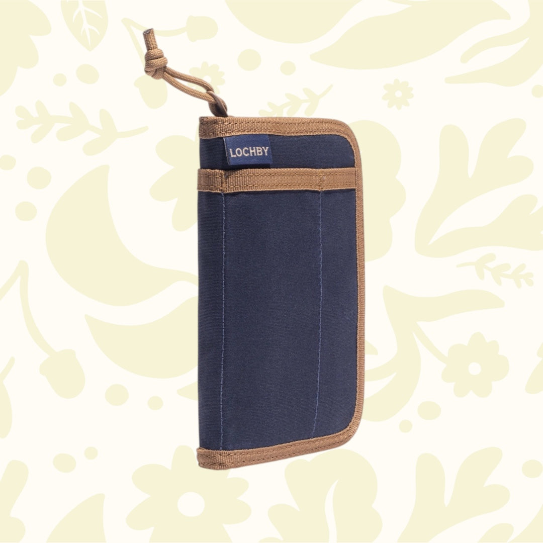 Lochby Pocket Journal Nautical with fountain pen paper rests on pastel floral background—premium writing accessory.