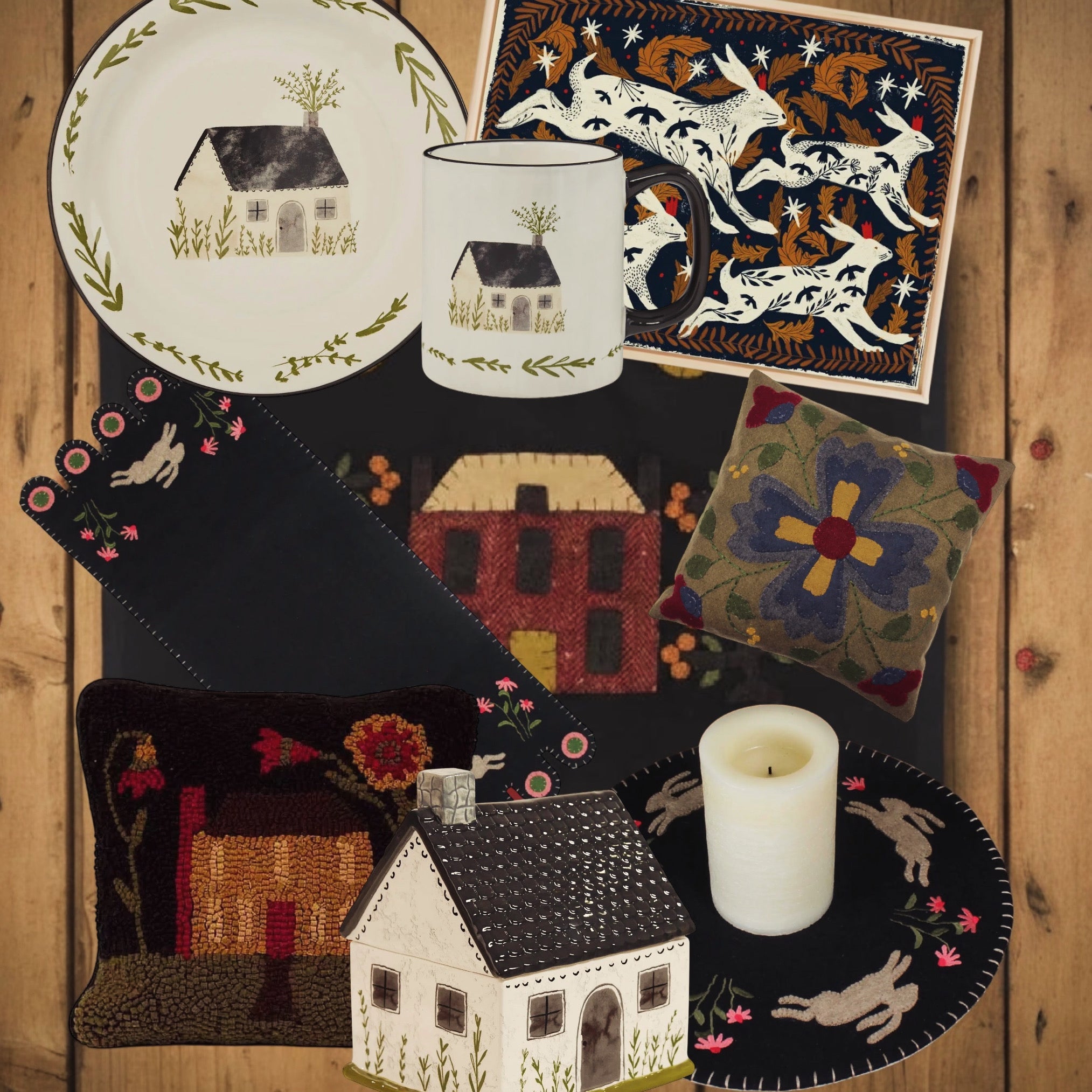 Folk art home decor on wood: hand-painted plates, pillows, candle, house ornament, and textiles with floral, animal, and geometric designs.