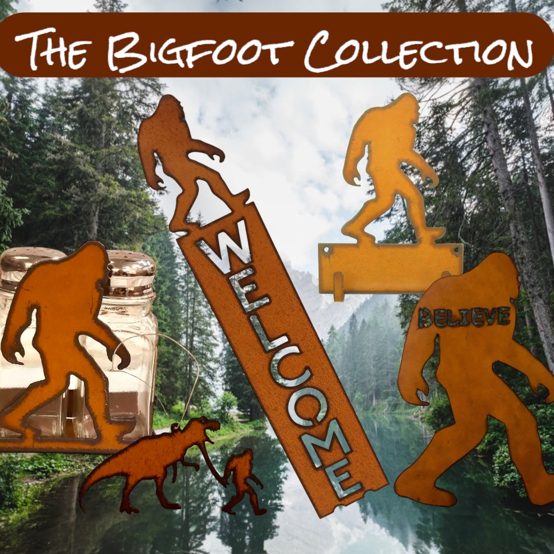 Bigfoot metal decor collection: silhouettes and WELCOME sign on a forest river backdrop, with The Bigfoot Collection text above.