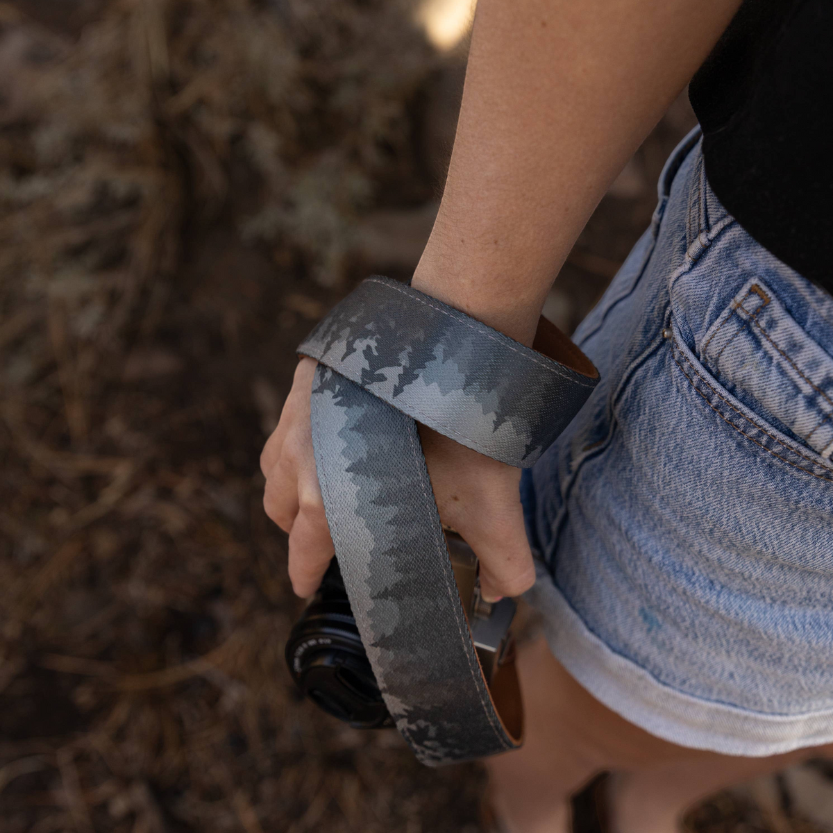 Forager Provisions LTD Wildtree Foggy Forest camera strap with mountain and evergreen tree print wrapped around a wrist