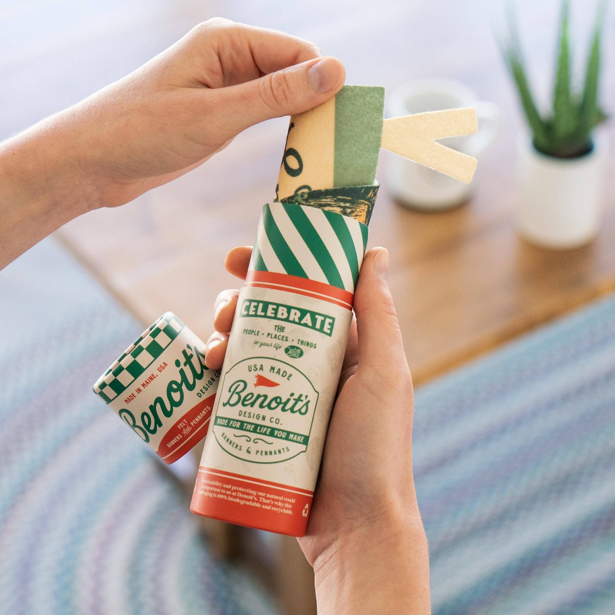 Forager Provisions LTD Benoit’s Supply Co. Krampus felt pennant being removed from its branded cardboard tube packaging.