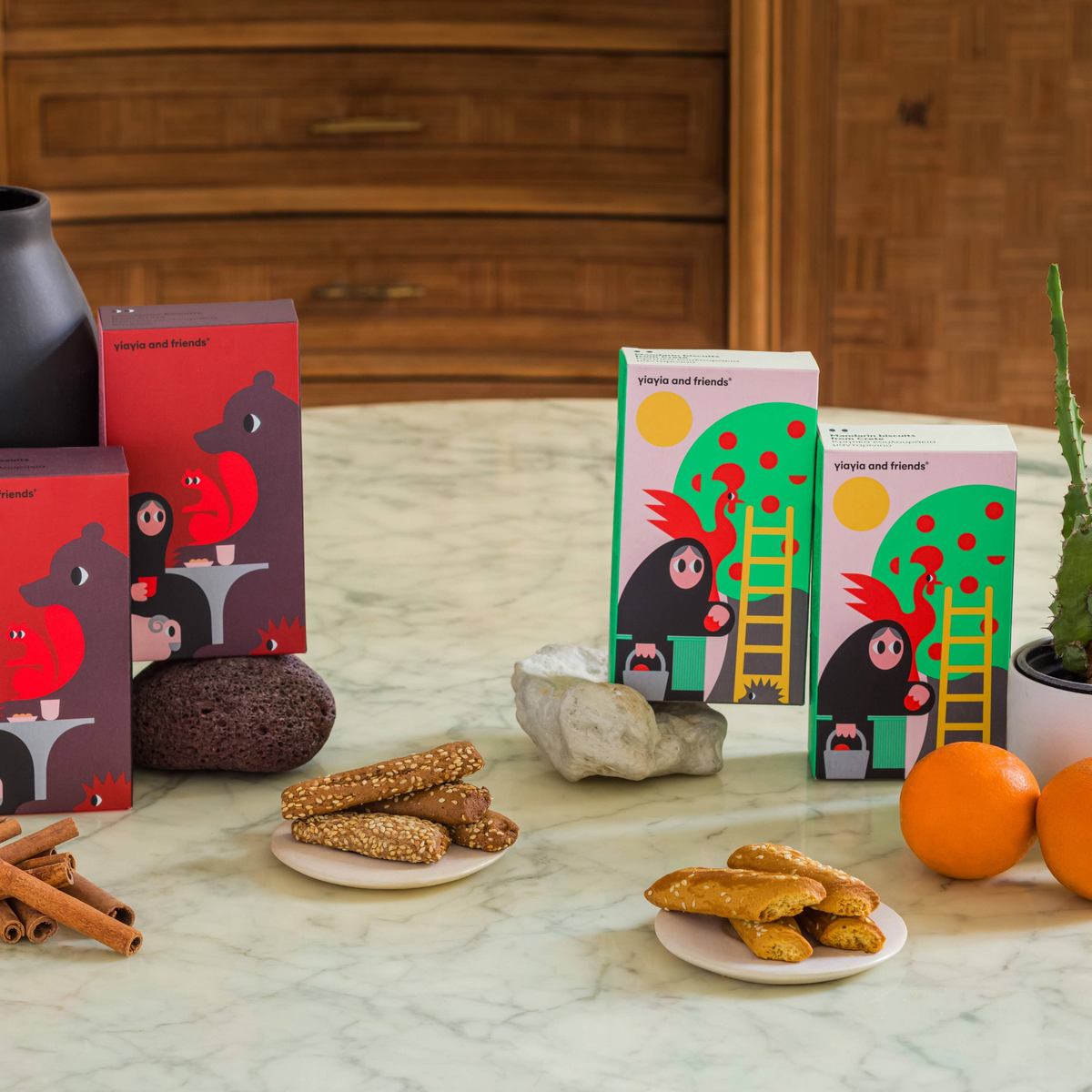 Forager Provisions LTD Mandarin Biscuits from Crete in illustrated boxes with sesame-topped cookies on small plates