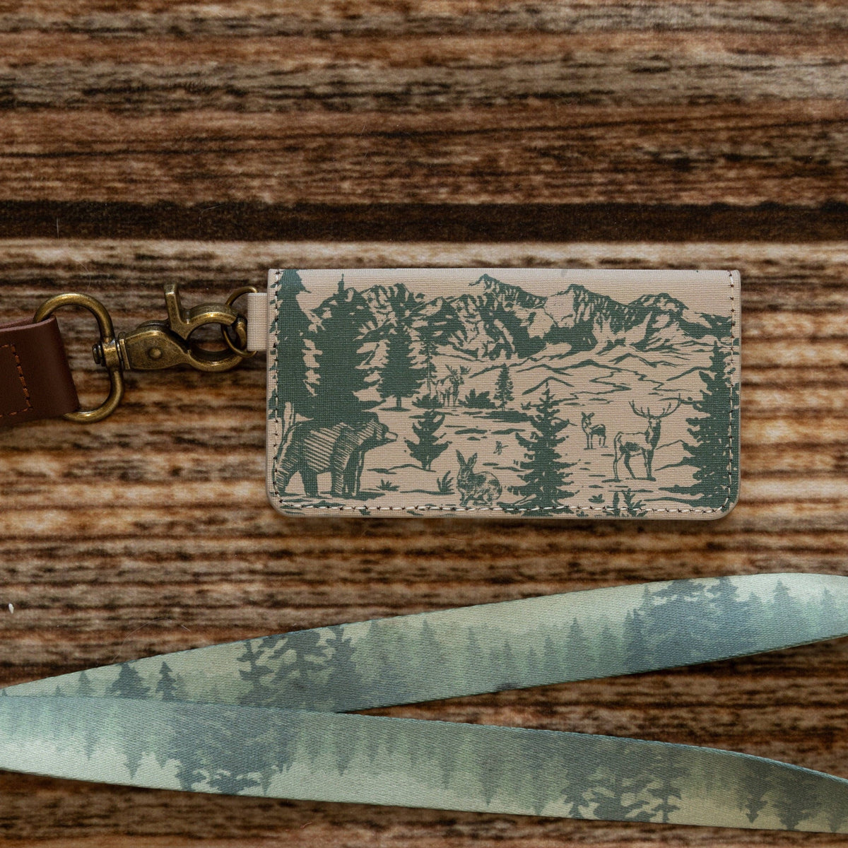 Forager Provisions LTD Wildtree Woodland Landscape card holder with matching forest print lanyard on wood background.