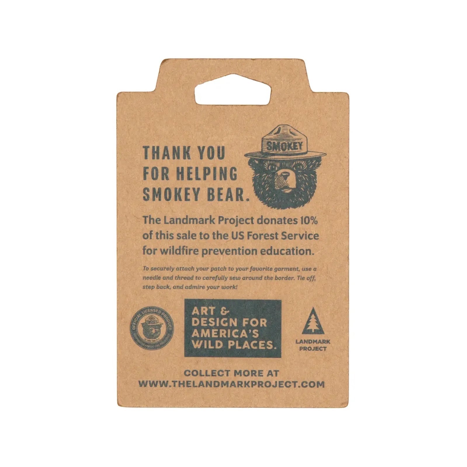The Landmark Project Smokey Bear Patch - Protect Our Forests features the iconic Smokey Bear logo and a message thanking you for your support in preventing wildfires. Additionally, 10% of proceeds are donated to the USDA Forest Service, and it proudly displays The Landmark Project branding.