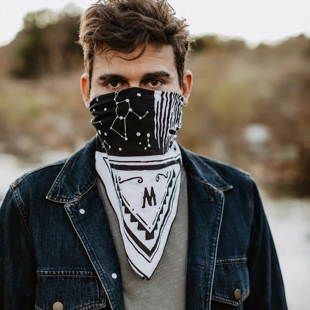 Man outdoors wears "Freedom Is" Bandit Bandanas face covering, stylish nose and mouth bandana mask for protection and fashion.