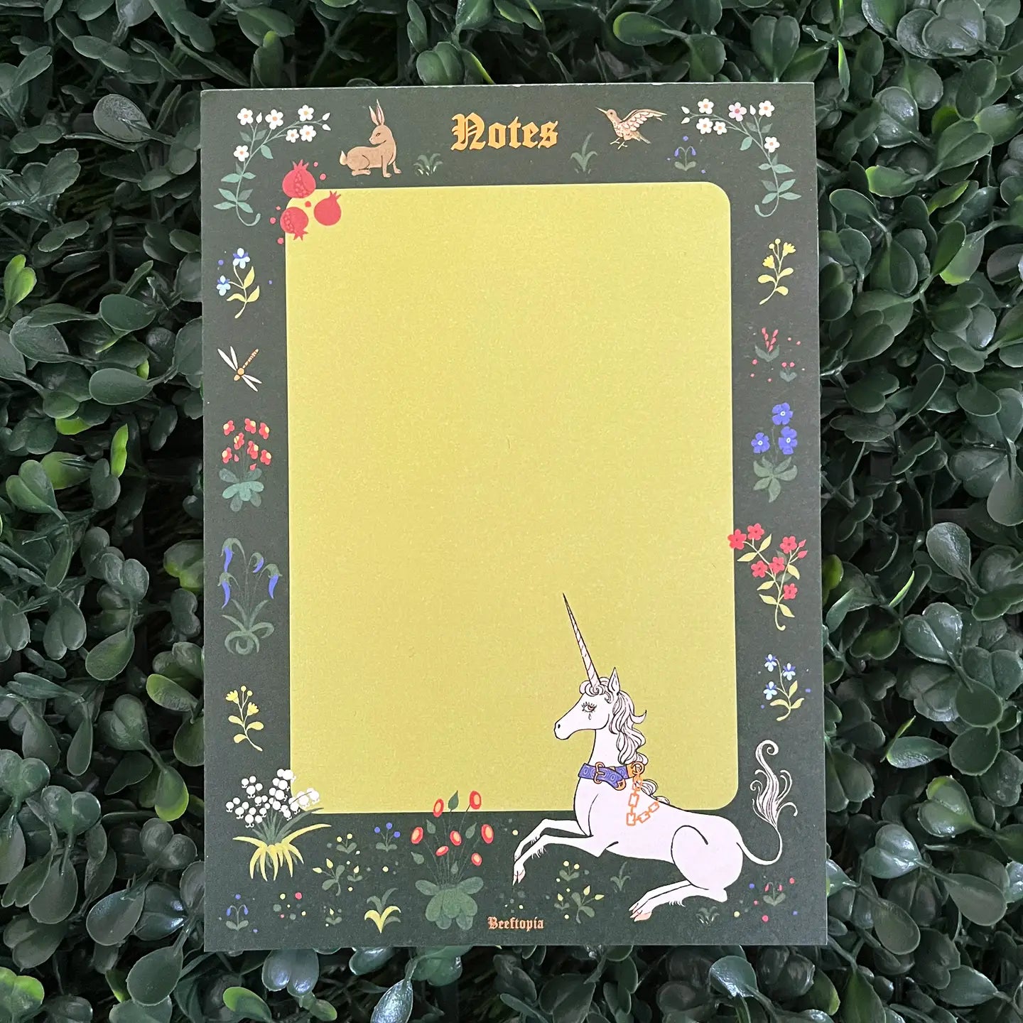 Beeftopia Unicorn Tapestry Medieval A6 Notepad with unicorn, flowers, and yellow center on green—unique stationery gift.