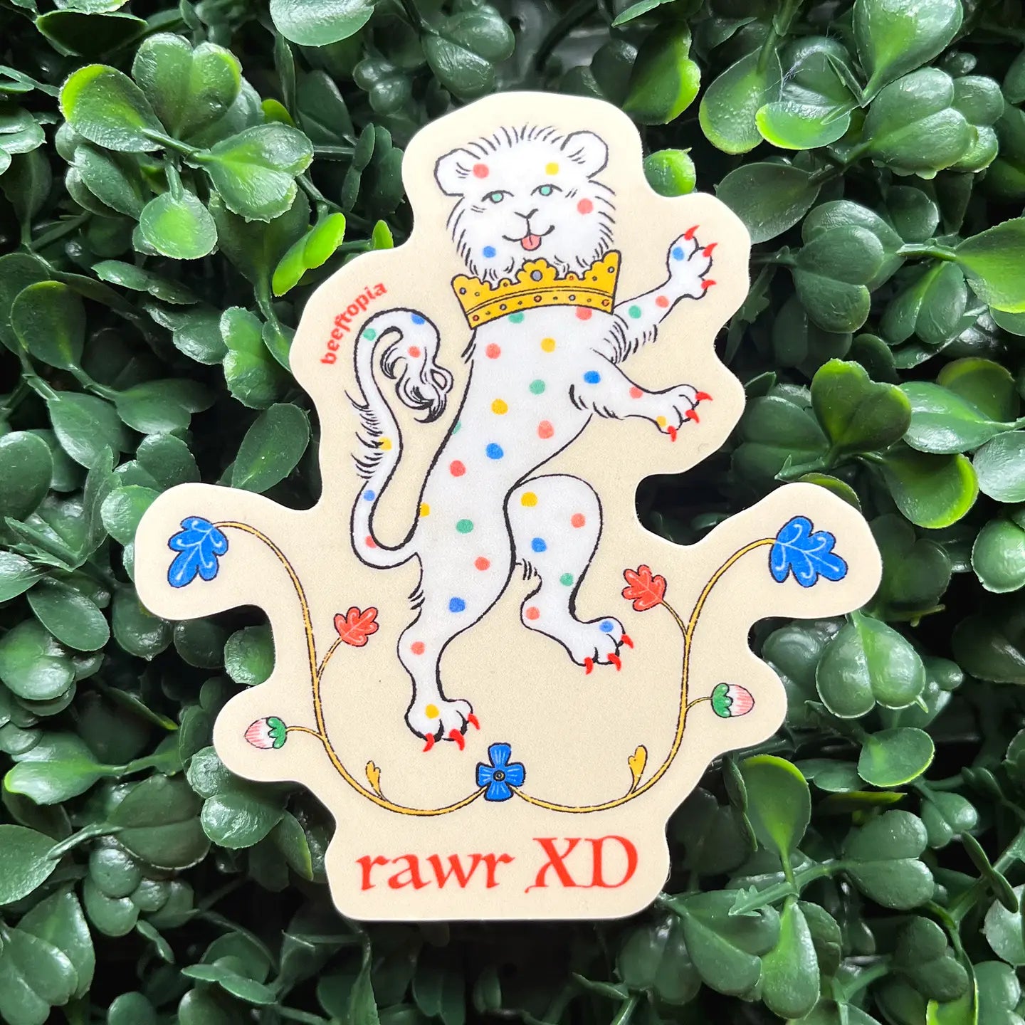 Beeftopia Rawr Xd Medieval Lion Sticker: crowned lion, vibrant dots, leaves, funny meme text; waterproof vinyl decal for laptops.