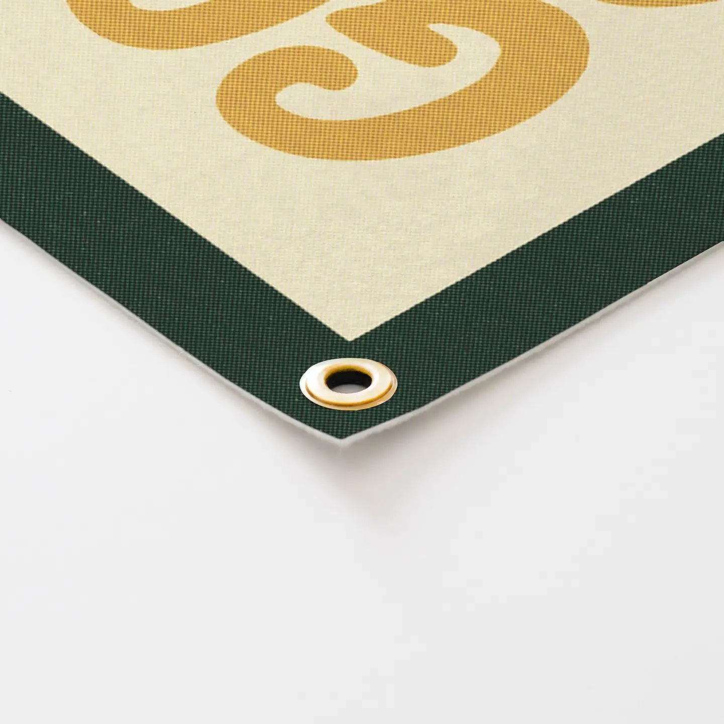 Close-up of Benoit’s Go Play Outside felt camp flag—green trim, gold grommet. Best cabin wall décor for camping lovers.