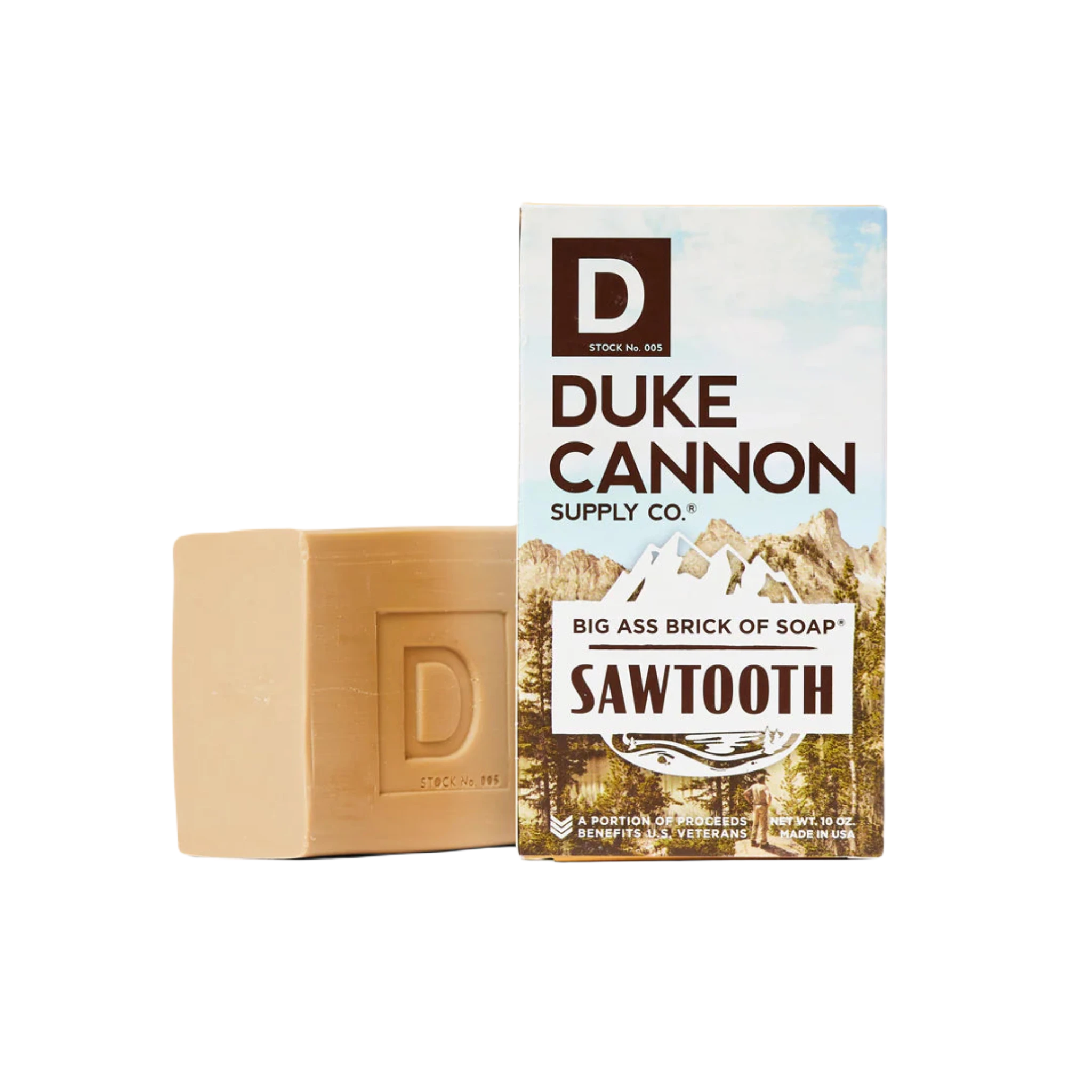 Duke Cannon Big Ass Brick Of Soap - Sawtooth, featuring RSPO Certified Palm Oil, stands next to its box displaying the brand's name and a mountain landscape.