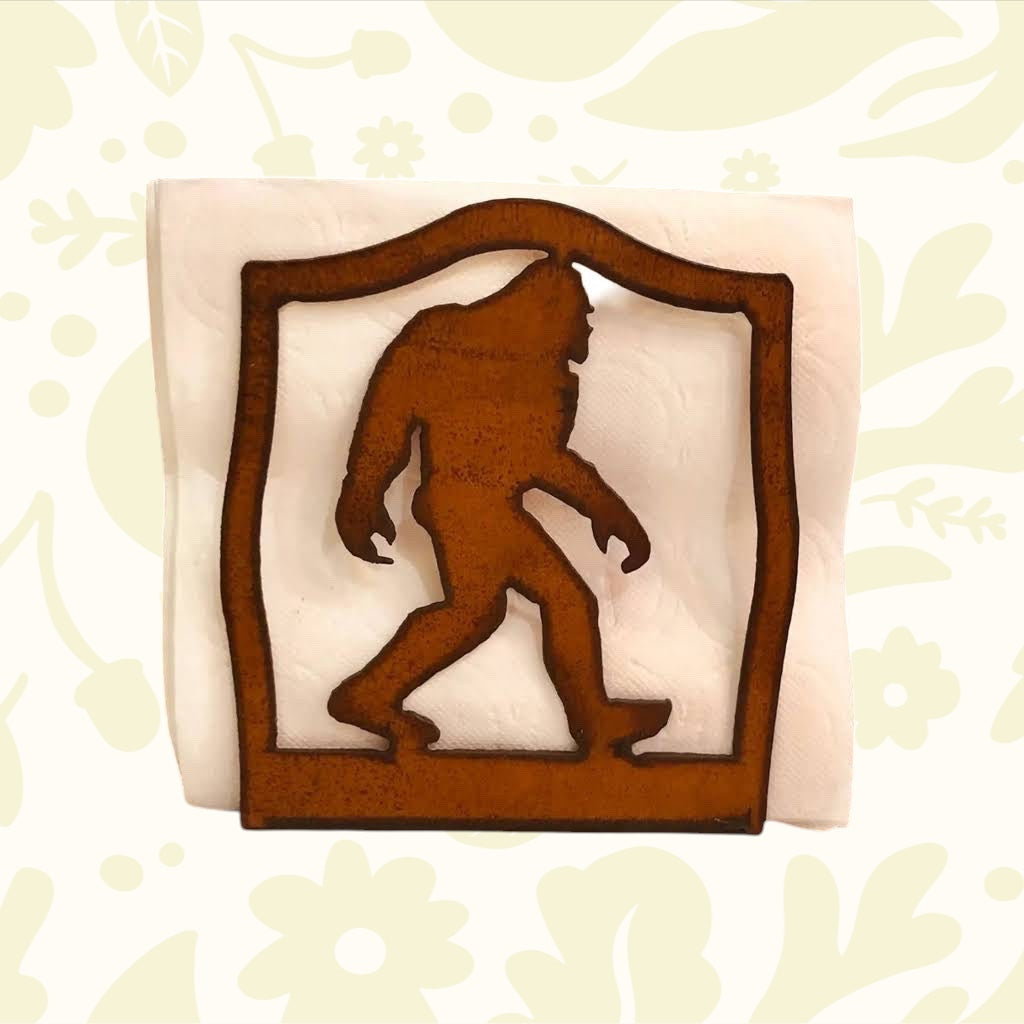 Forager Provisions LTD rustic steel napkin holder featuring a laser-cut Bigfoot silhouette for woodland kitchen decor.