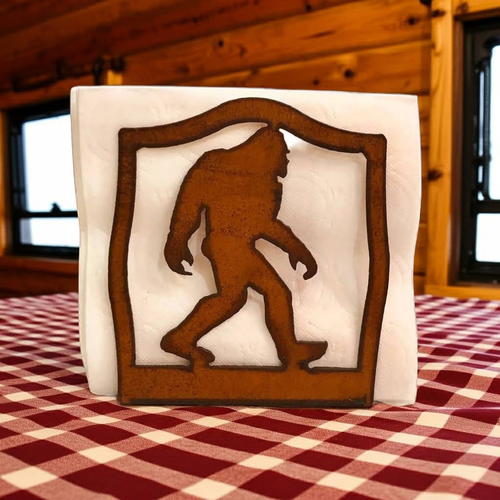 Forager Provisions LTD rustic steel napkin holder featuring a Bigfoot silhouette on a red and white checkered cloth