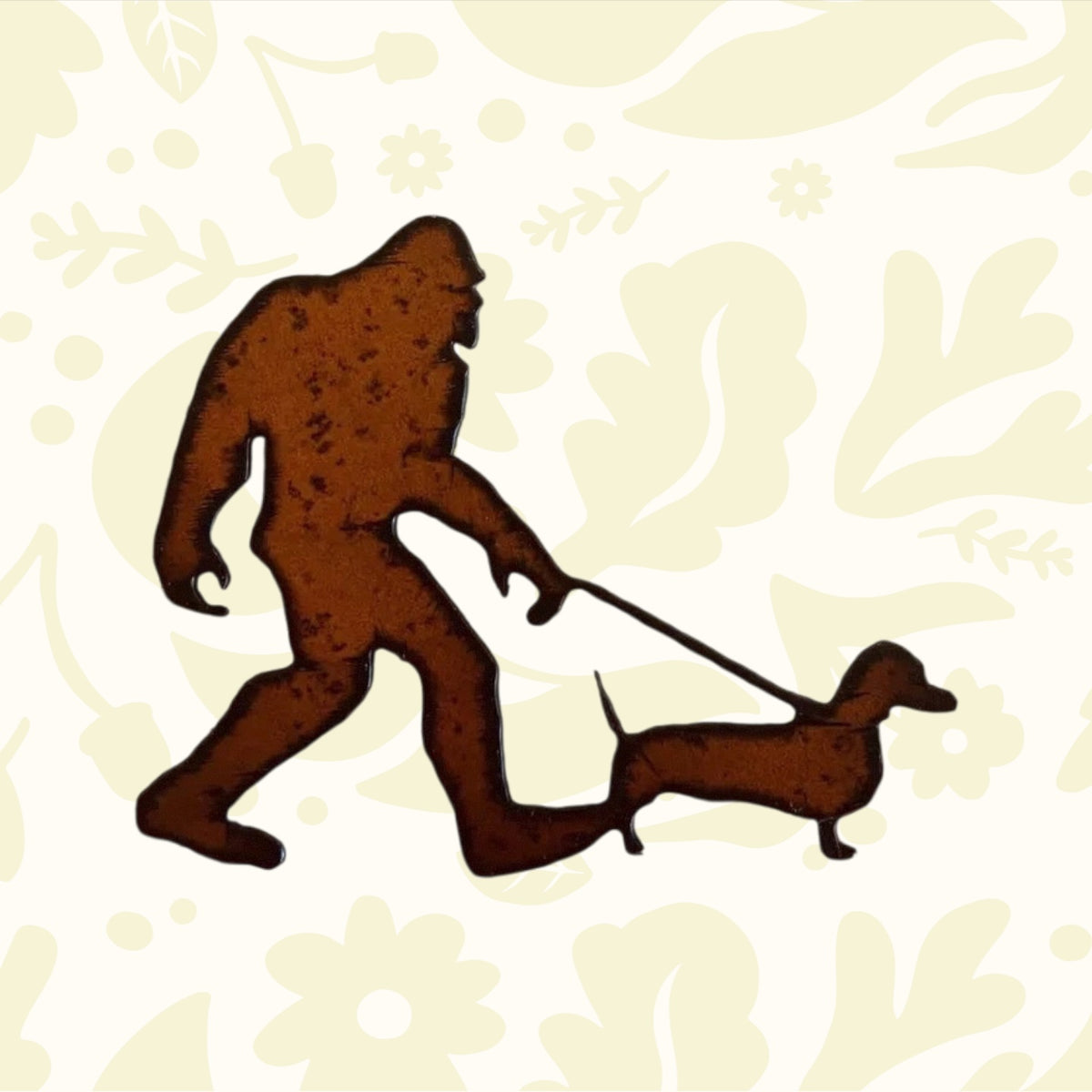 Metallic brown silhouette of a person walking a dog on a leash against a white background