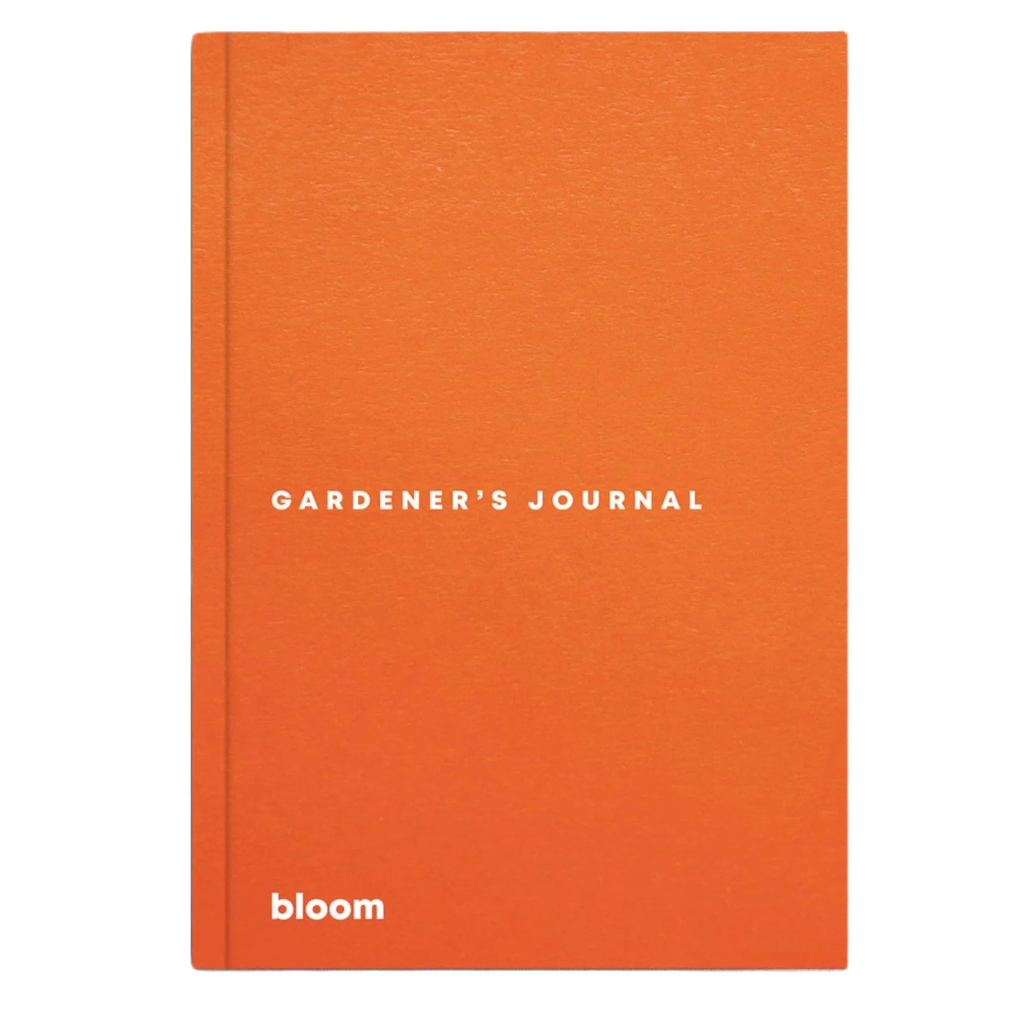 The BLOOM Gardeners Journal in orange, featuring the "bloom" logo at the bottom along with sowing calendars and seasonal tasks, placed on a gray surface.