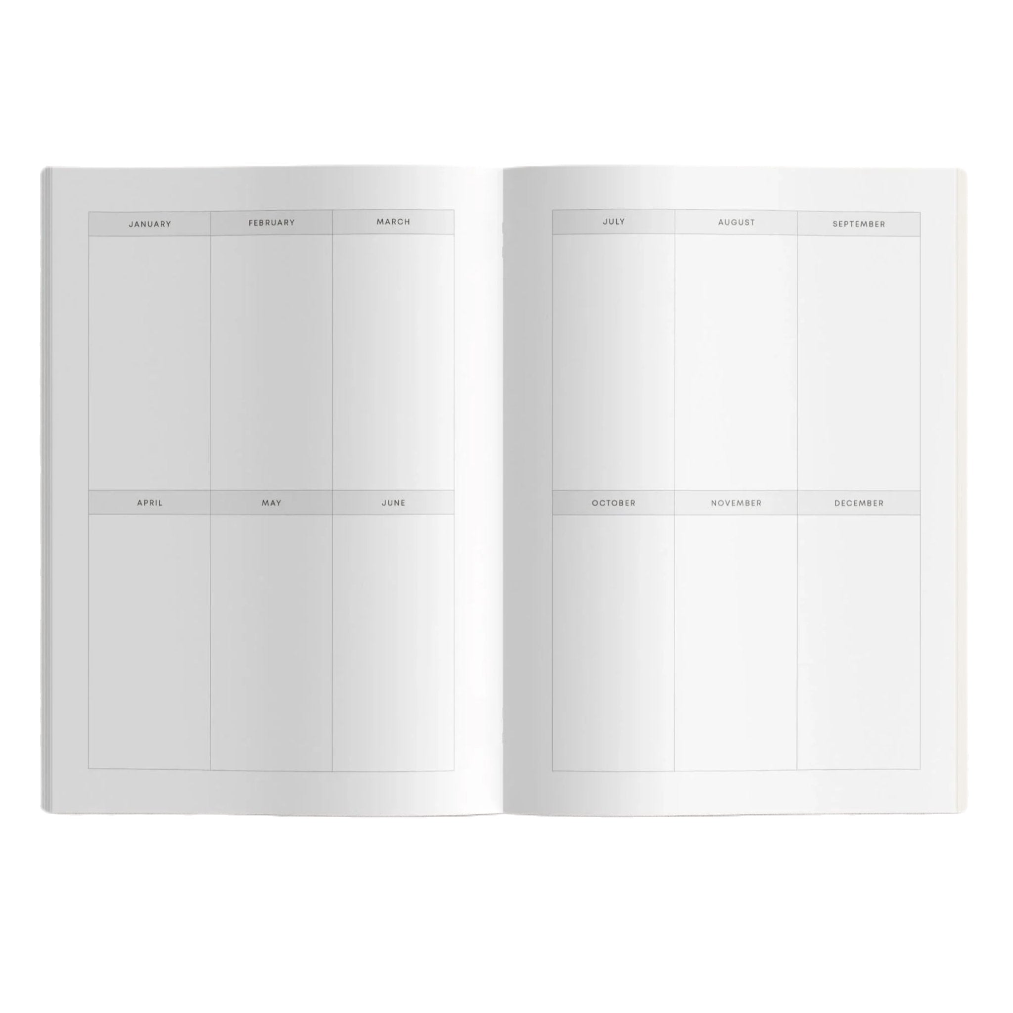 The BLOOM Gardeners Journal in orange, featuring the "bloom" logo at the bottom along with sowing calendars and seasonal tasks, placed on a gray surface.