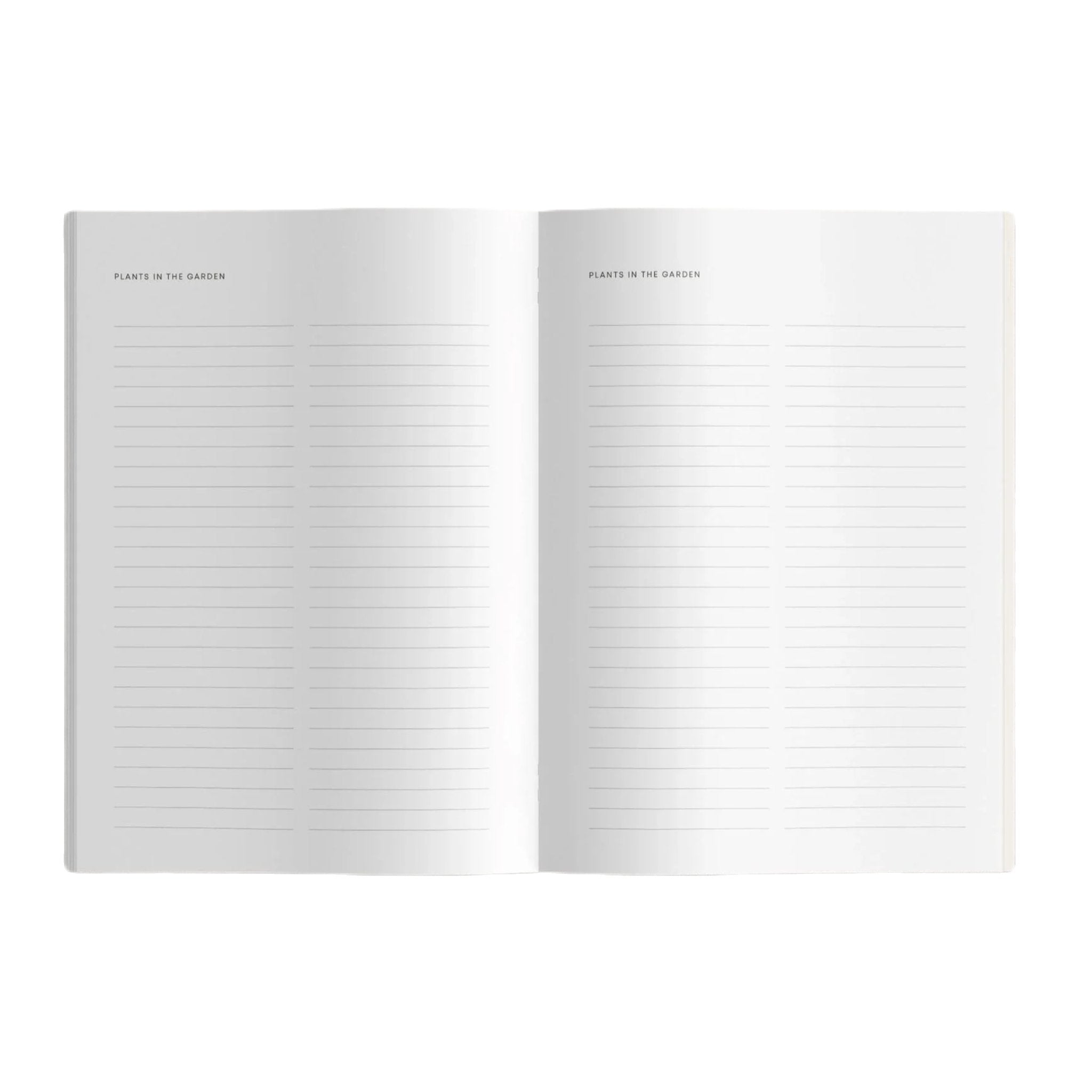 The BLOOM Gardeners Journal in orange, featuring the "bloom" logo at the bottom along with sowing calendars and seasonal tasks, placed on a gray surface.