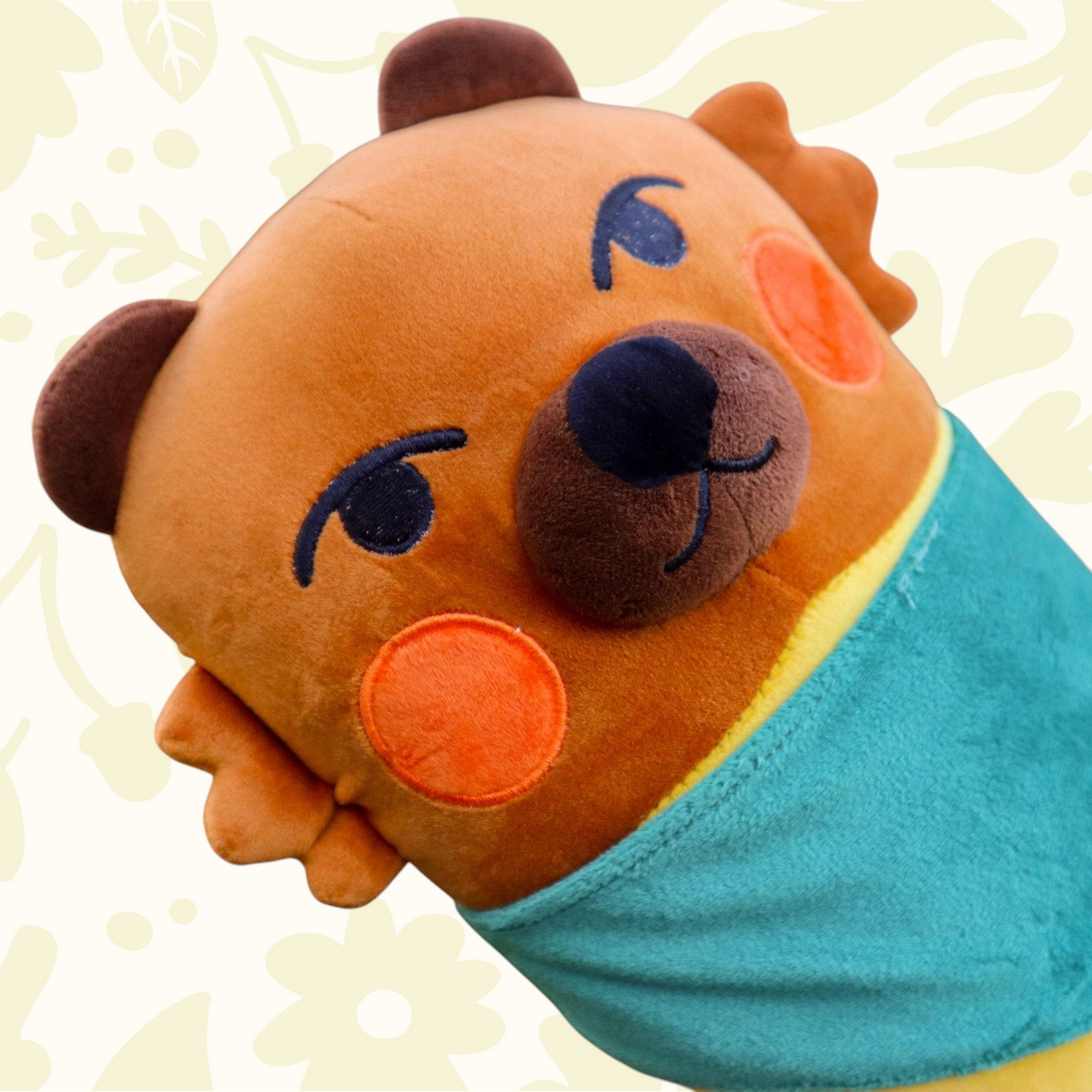 Camp Mustelid European Marten Plush toy with orange cheeks and teal blanket, held by person. Cute stuffed animal gift idea.