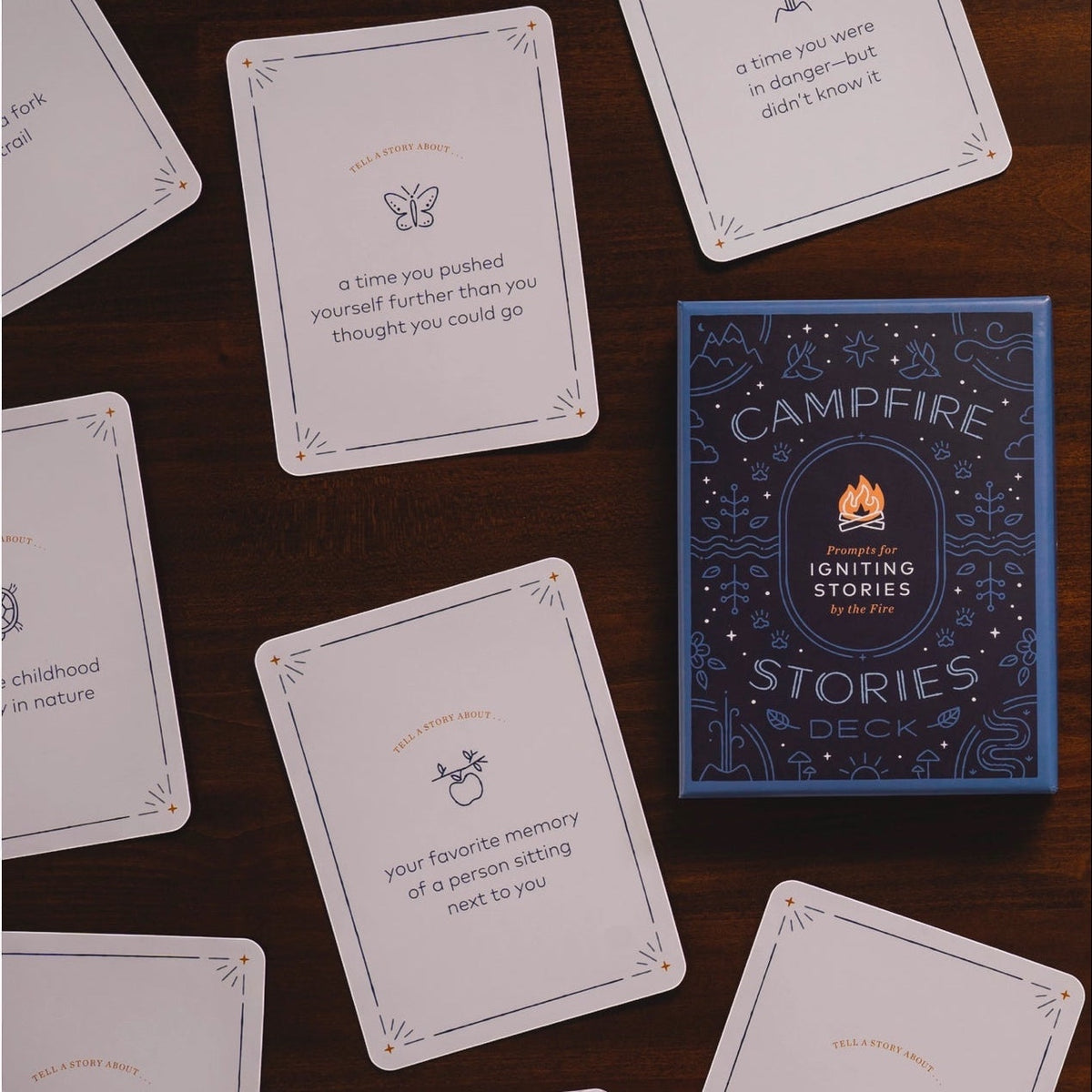 Forager Provisions LTD Campfire Stories Deck with illustrated question cards on a dark wooden surface