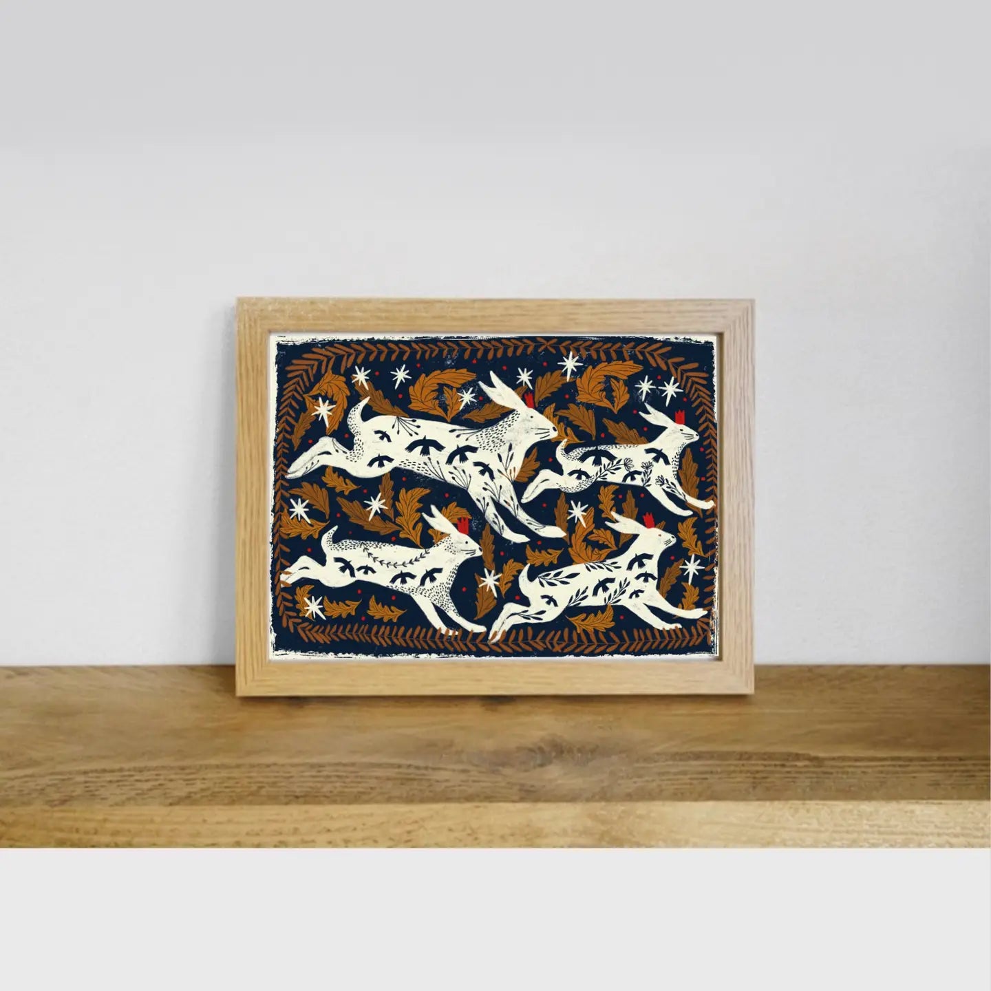 Carole Hillman French Folk Hares Dark Blue Greeting Card with folk art, displayed on wooden shelf—unique artisan stationery.