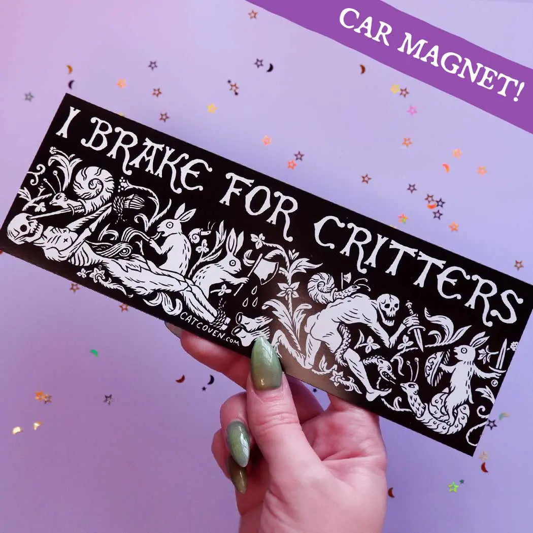 Hand displays Cat Coven I Brake For Critters Car Magnet with unique animal artwork; perfect for animal lovers and car decor.