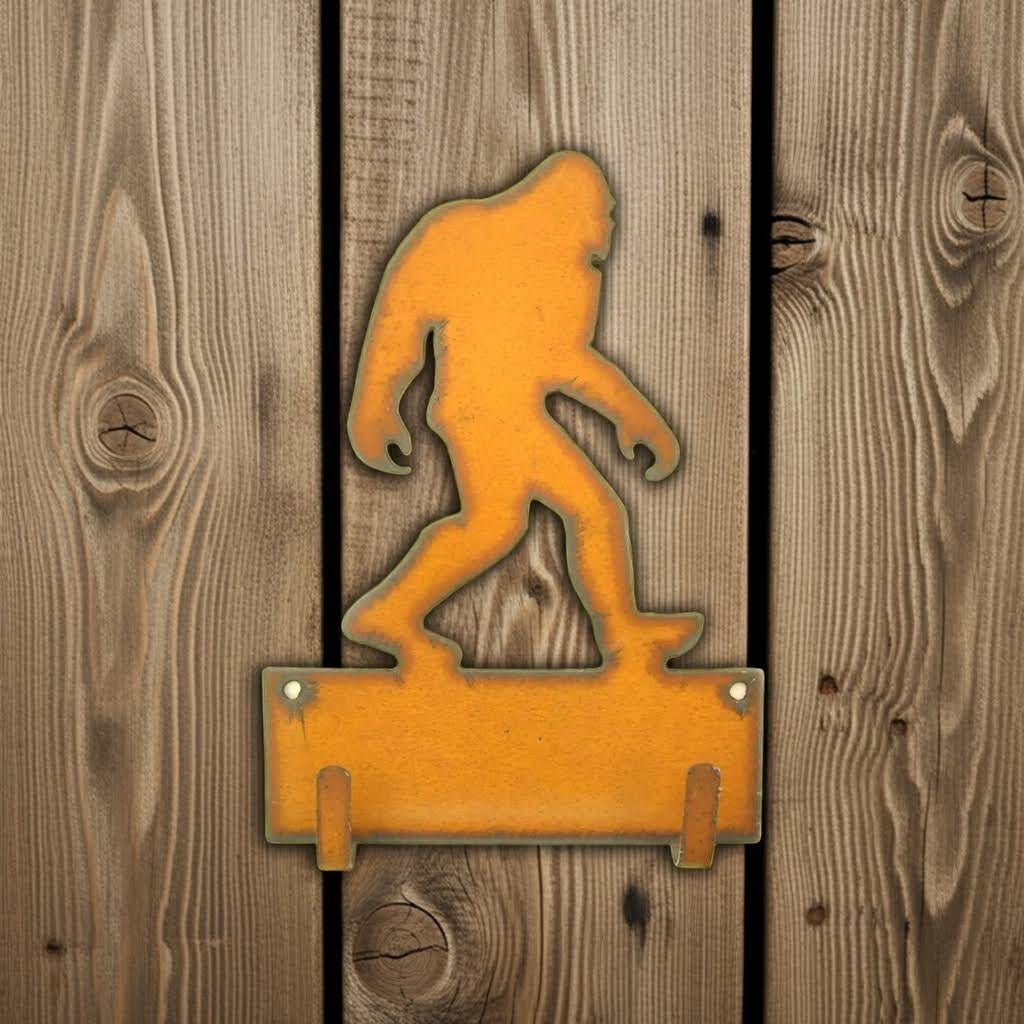 Forager Provisions LTD rustic steel Bigfoot double key hook with a weathered orange finish on a wooden wall