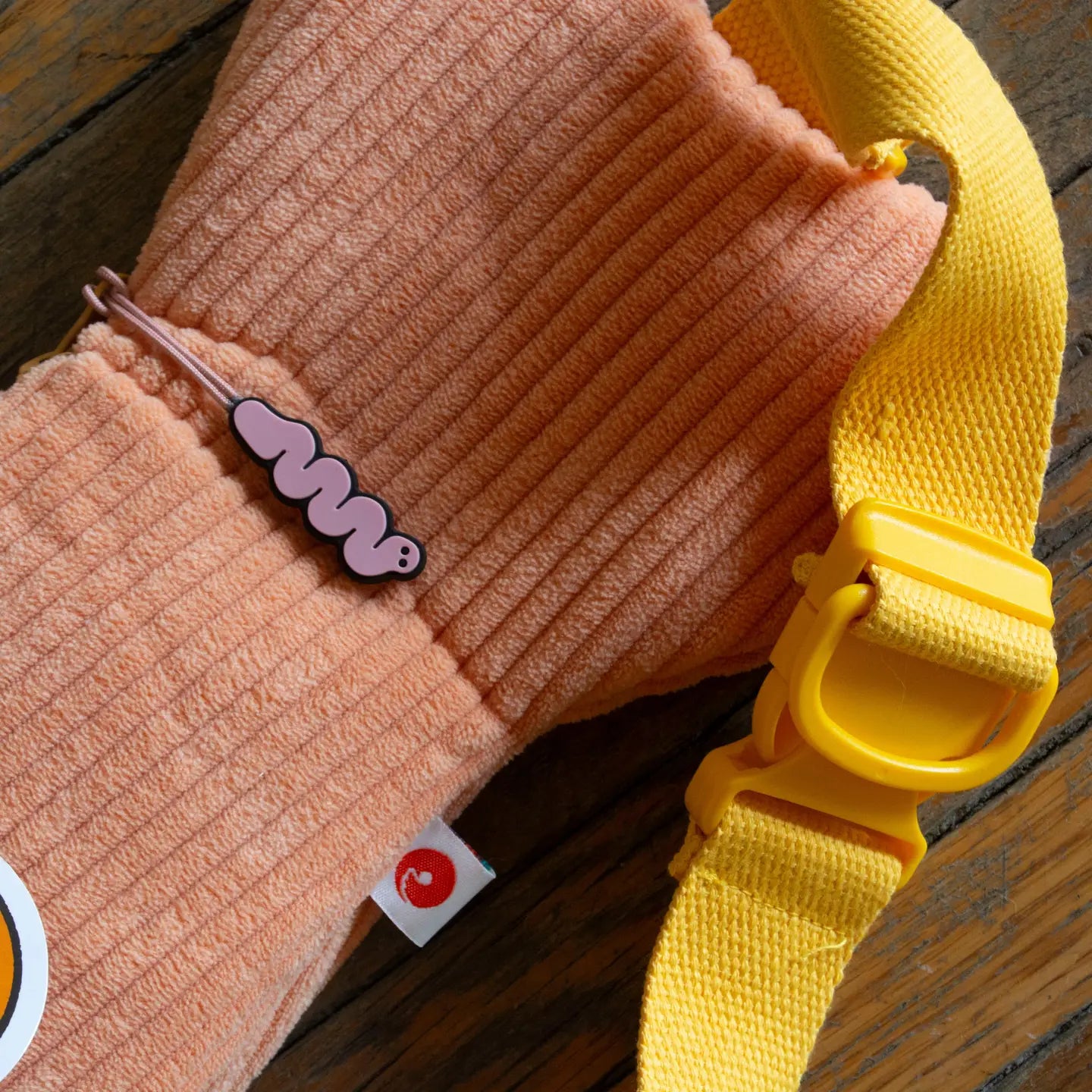 Curlworks Fish Bag crossbody, coral salmon & dark green, yellow strap, pink wavy pin—unique quirky fashion accessory.