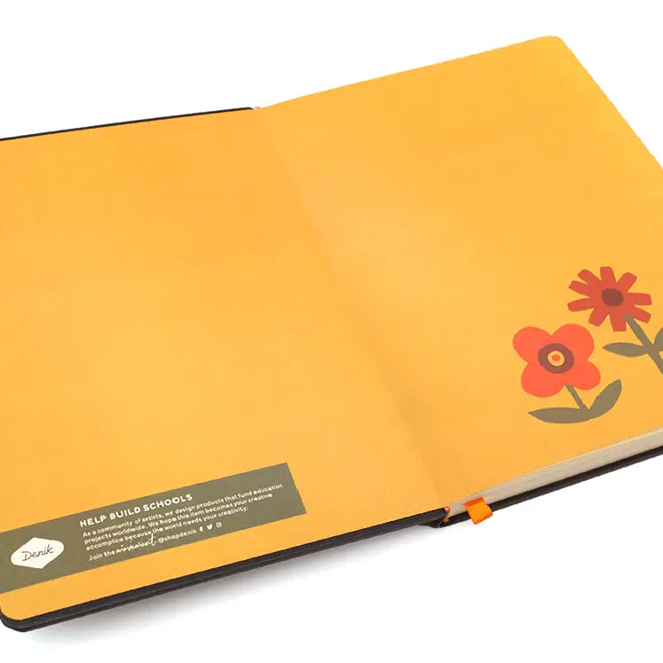 Forager Provisions LTD Denik journal open to yellow endpapers with simple red and orange flower illustrations.