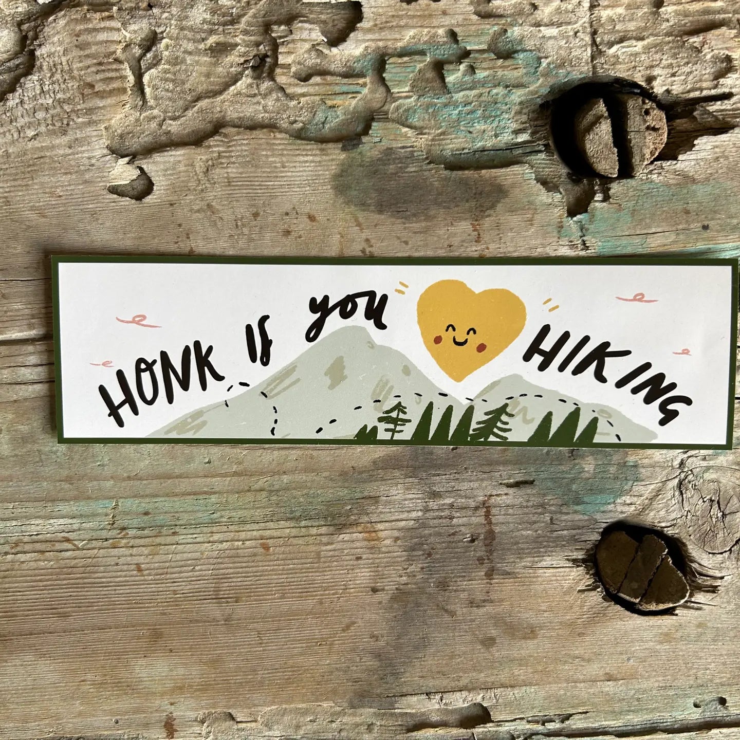 Honk If You Like Hiking bumper sticker: yellow heart, mountains, trees design—perfect outdoor car decal for hikers and nature lovers.